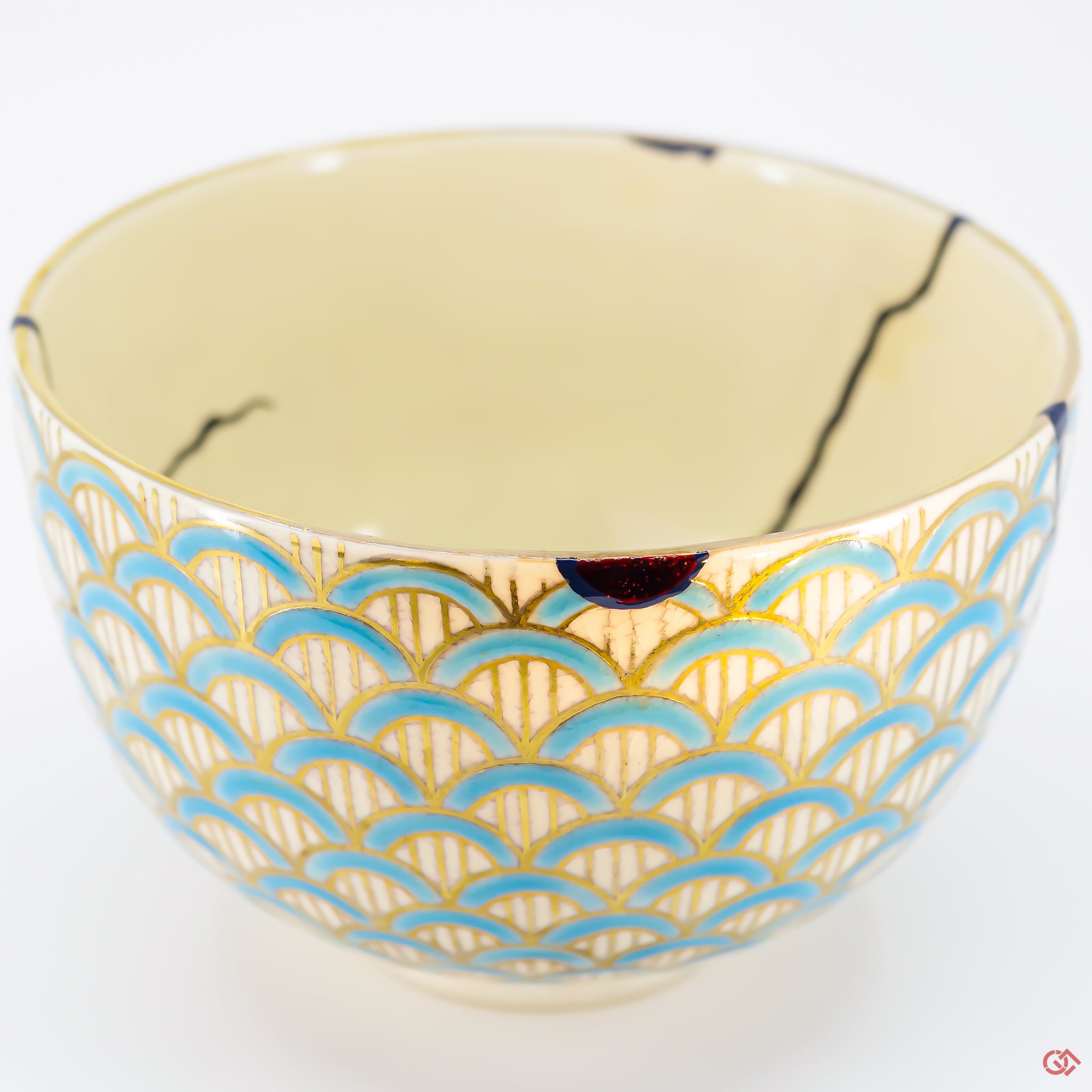 A close-up photo of an authentic Kintsugi pottery piece, showing the detail of its repairs and craftsmanship.