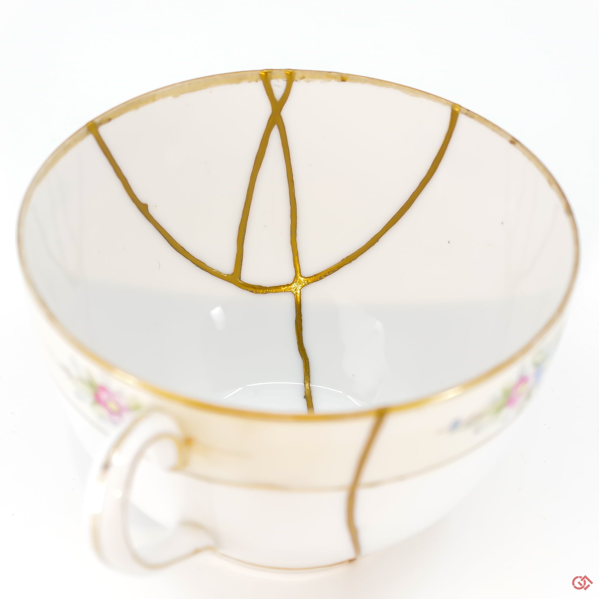 A close-up photo of an authentic Kintsugi pottery piece, showing the detail of its repairs and craftsmanship.
