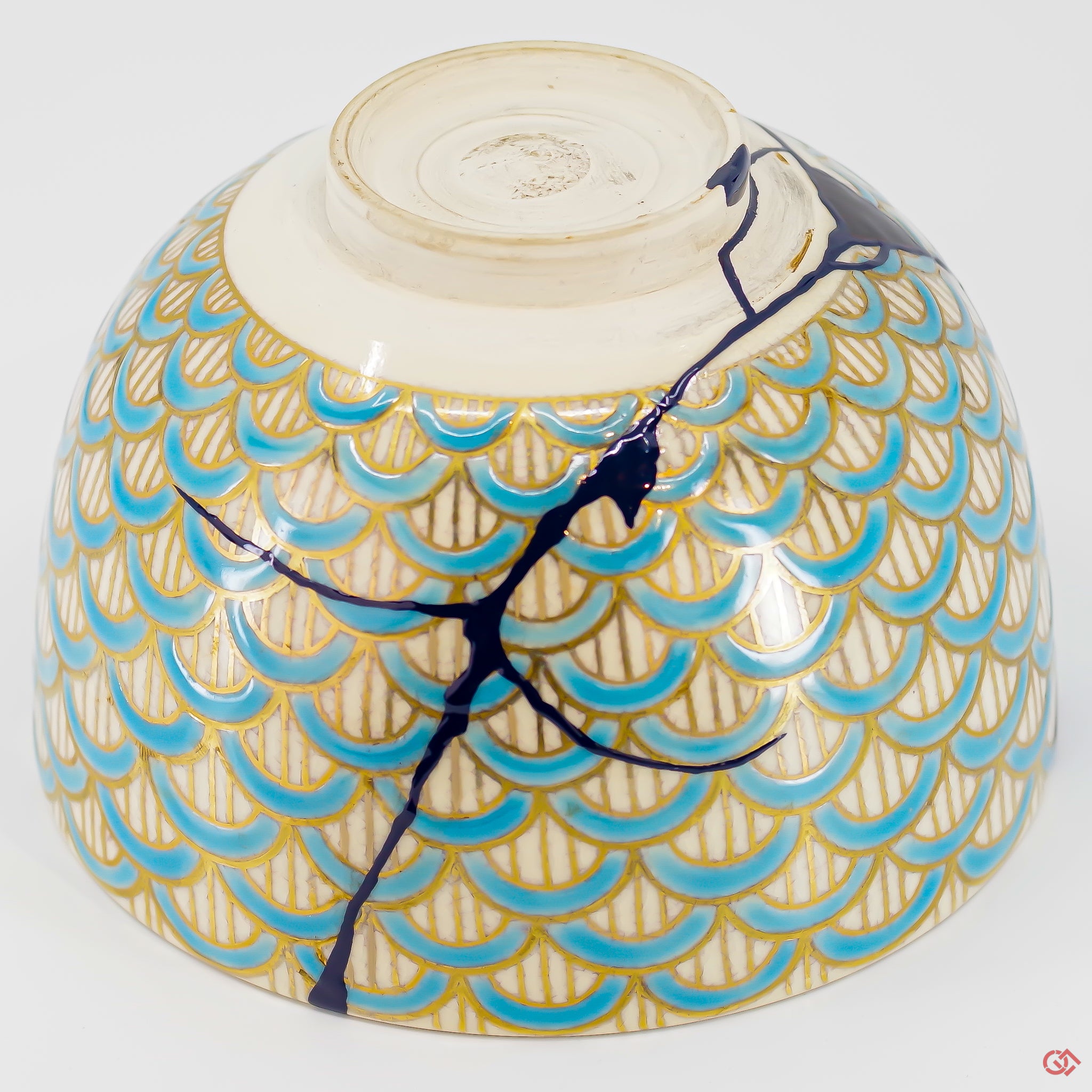 A close-up photo of an authentic Kintsugi pottery piece, showing the detail of its repairs and craftsmanship.