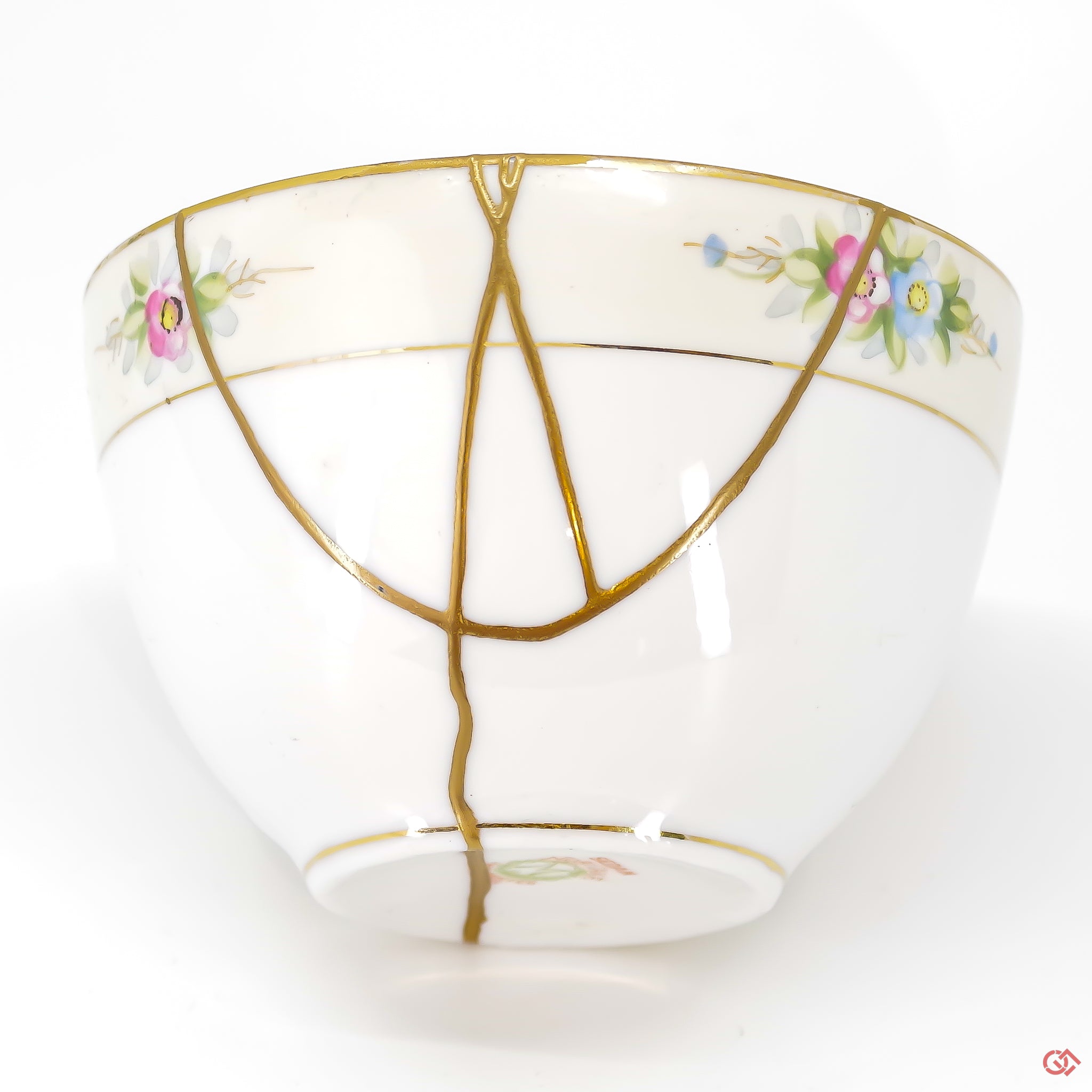 A close-up photo of an authentic Kintsugi pottery piece, showing the detail of its repairs and craftsmanship.