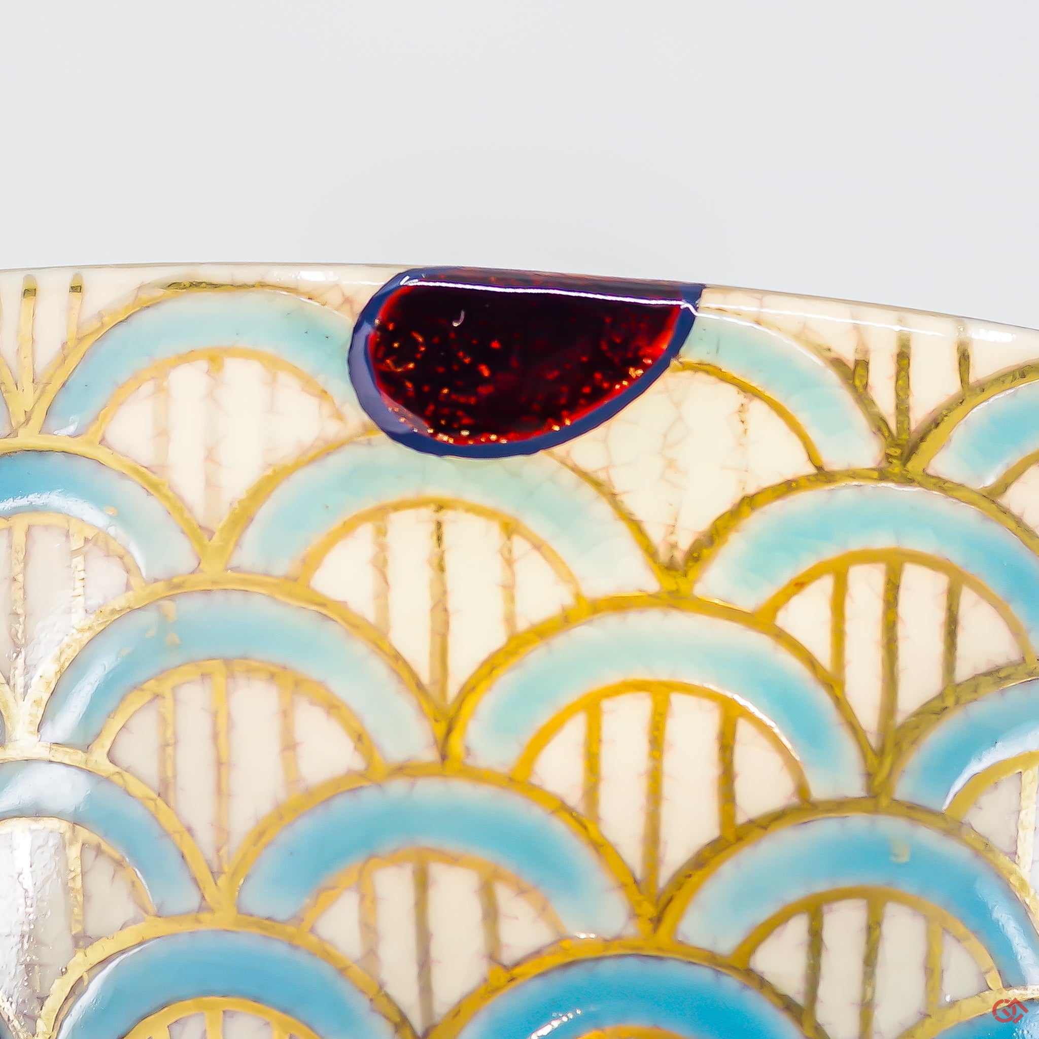 A close-up photo of an authentic Kintsugi pottery piece, showing the detail of its repairs and craftsmanship.