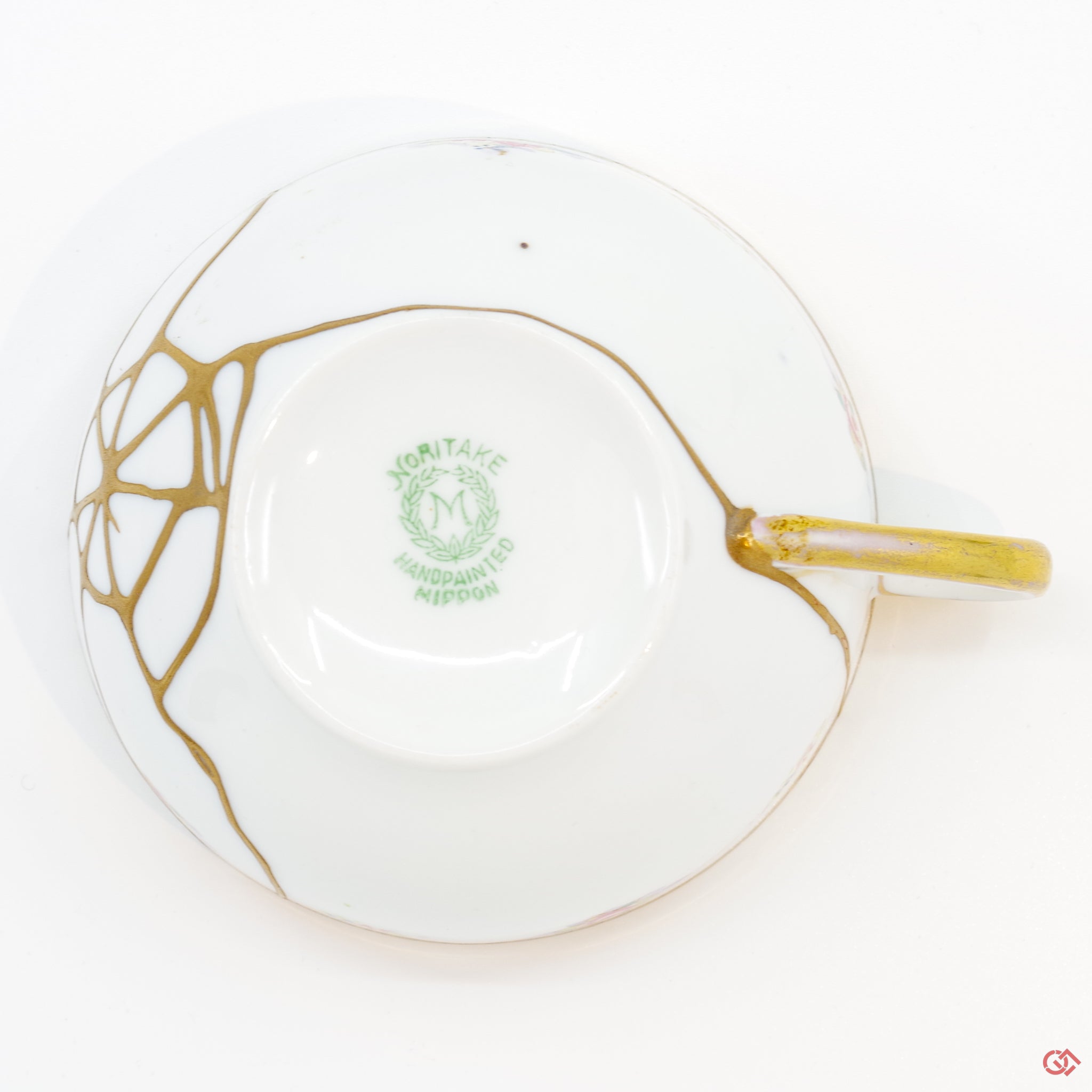 Photo of the bottom side of an authentic Kintsugi pottery piece, showing its overall design and features