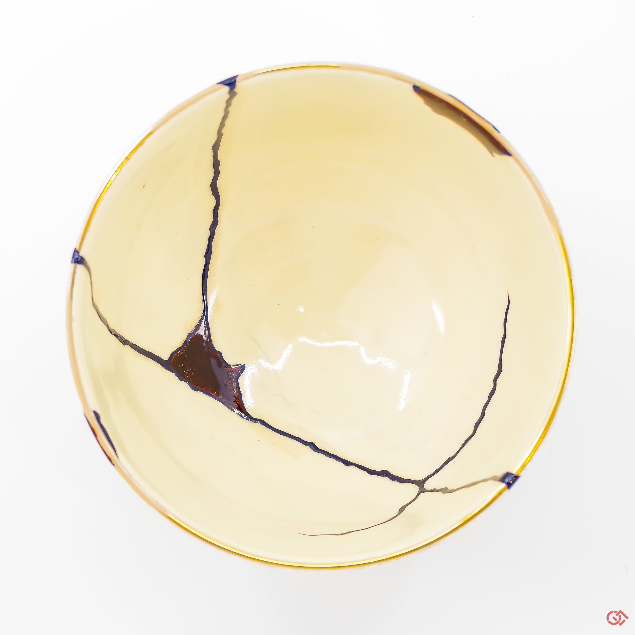 A photo of the top of an authentic Kintsugi pottery piece, showing its overall design and features.