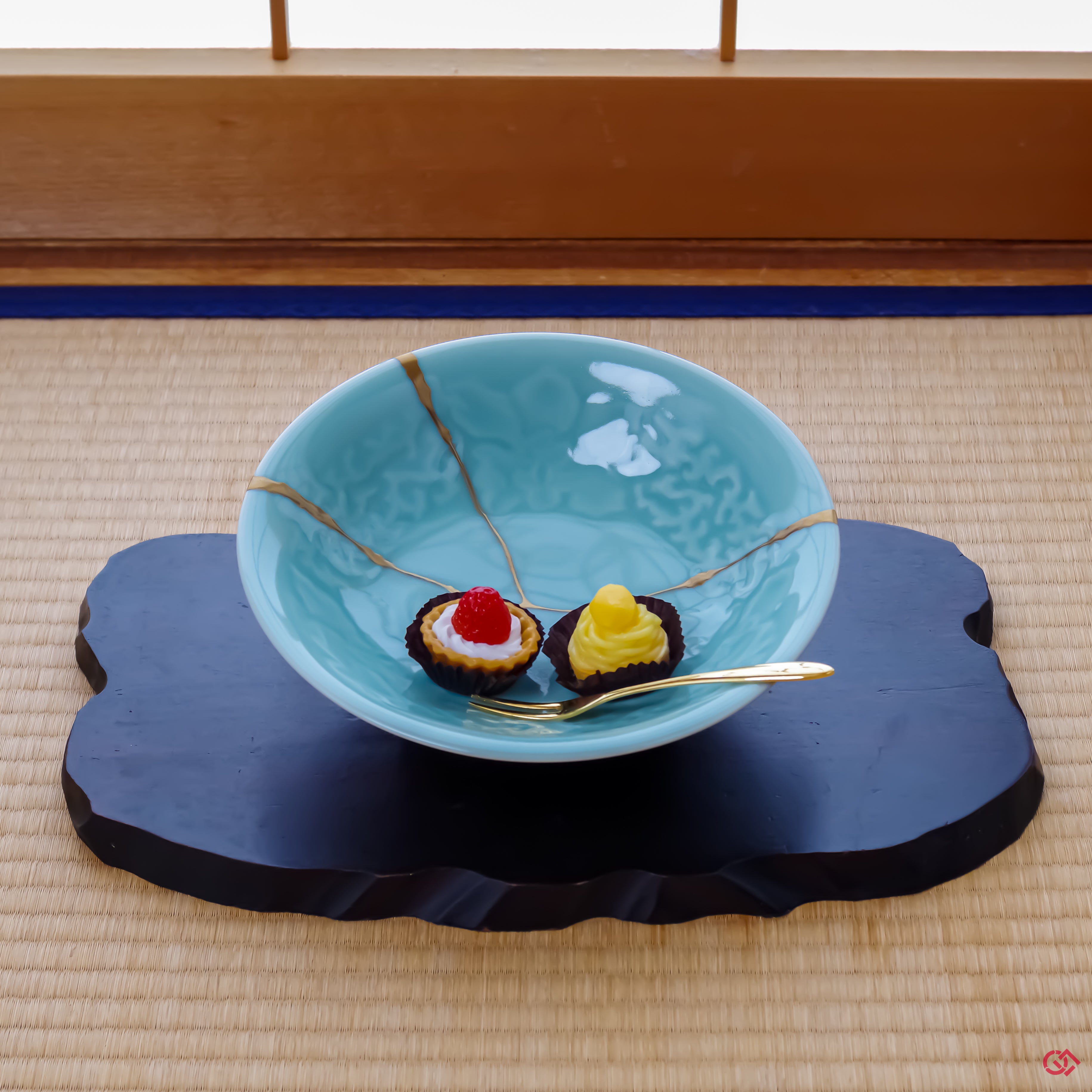 A photo of an authentic piece of Kintsugi pottery being used in a real-world setting, such as some cupcakes served on a Kintsugi plate.