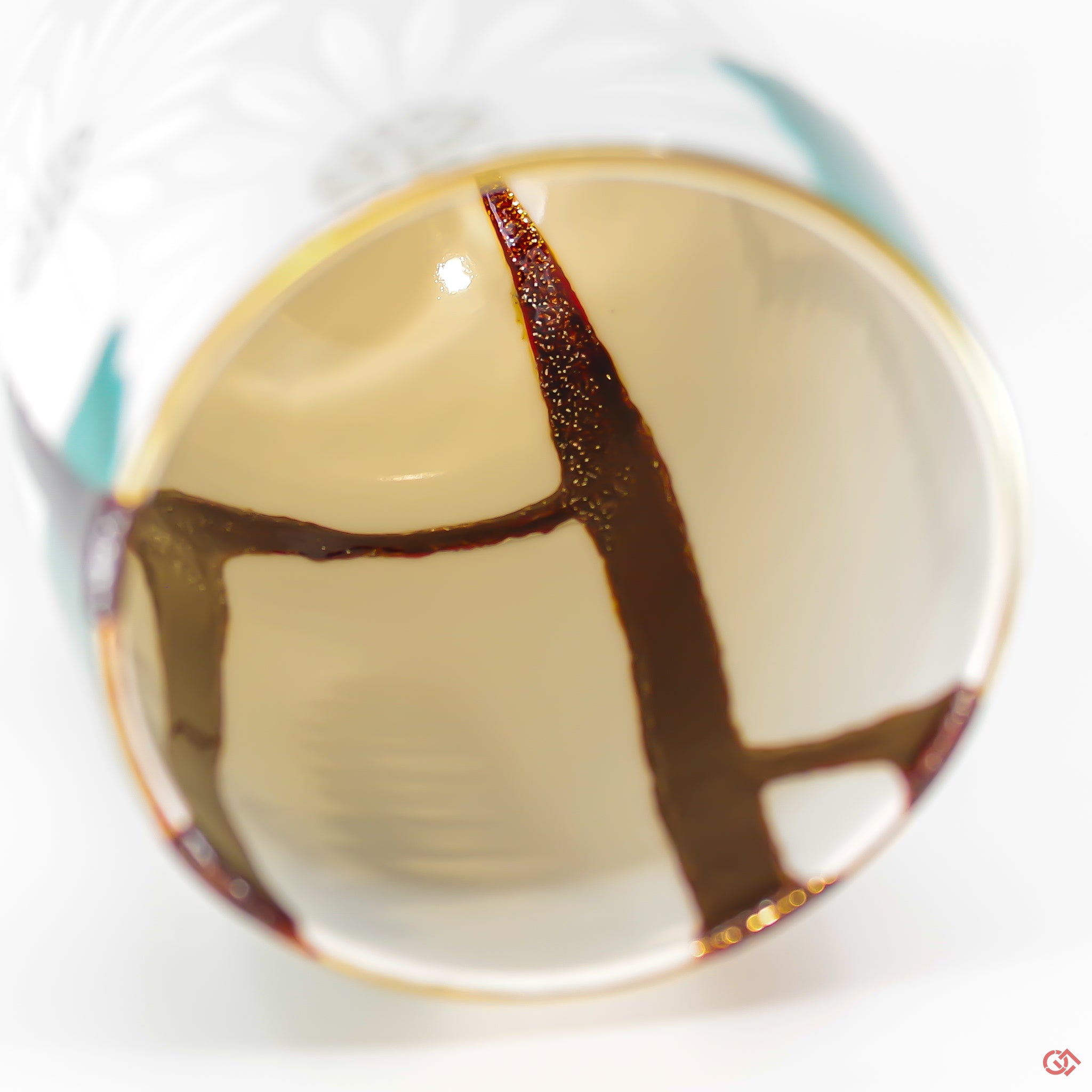 A close-up photo of an authentic Kintsugi pottery piece, showing the detail of its repairs and craftsmanship.