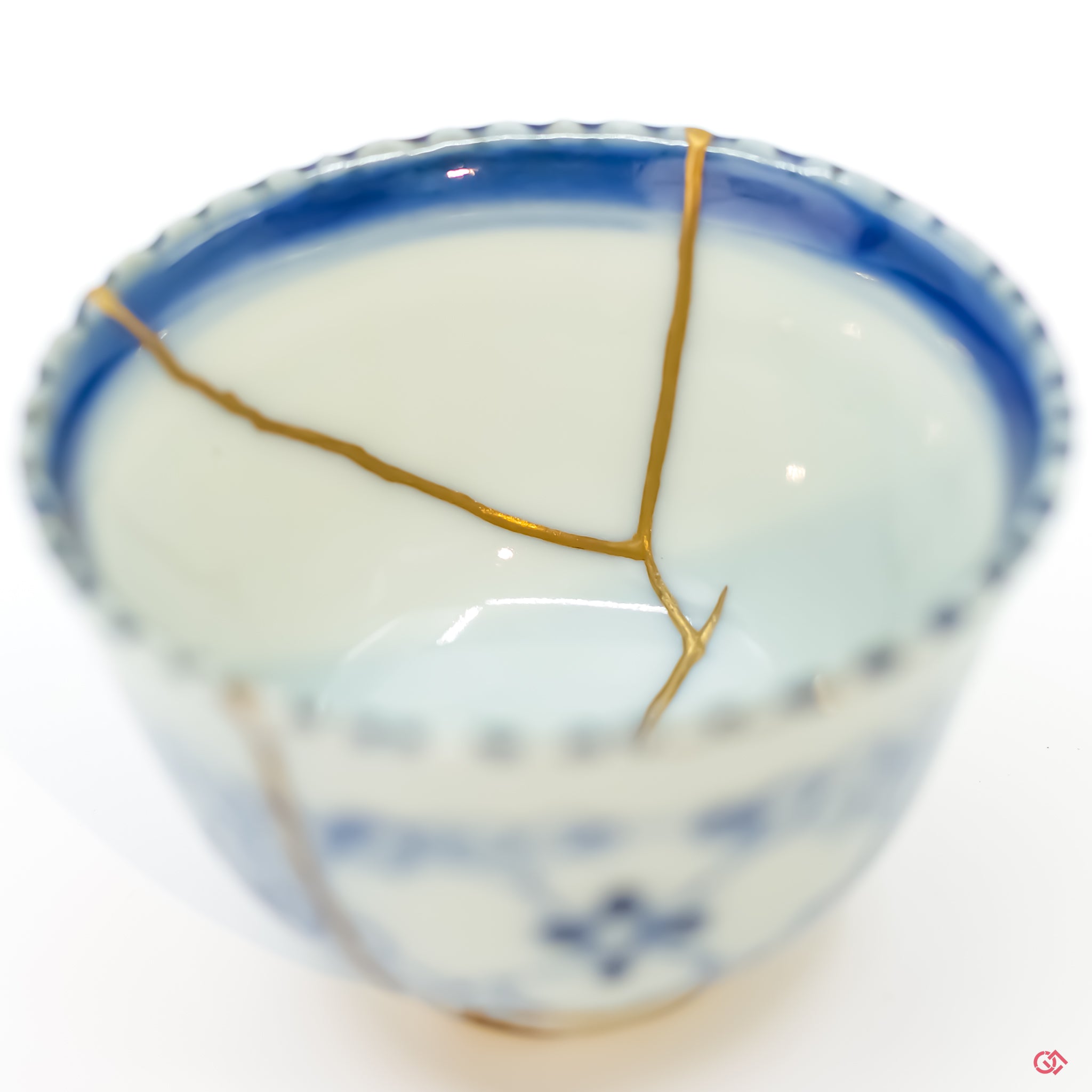 Detailed close-up of authentic Kintsugi pottery, showcasing the delicate gold lines of the repair and the artisan's craftsmanship.