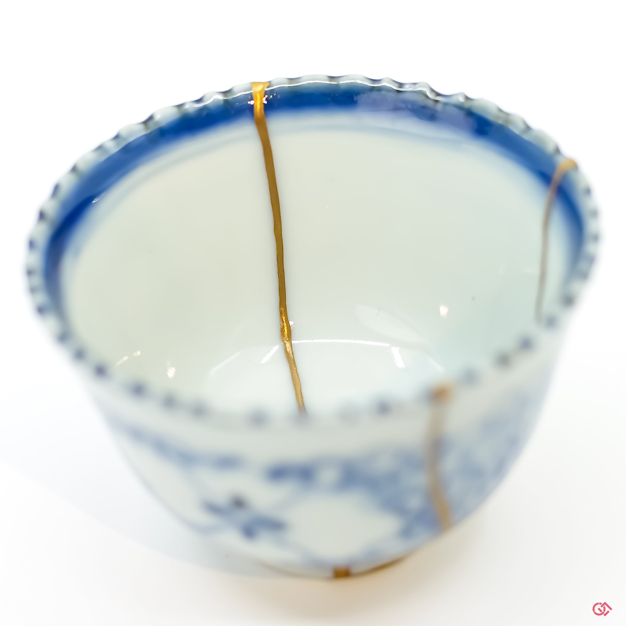 Detail of intricate gold Kintsugi repair on ceramic.