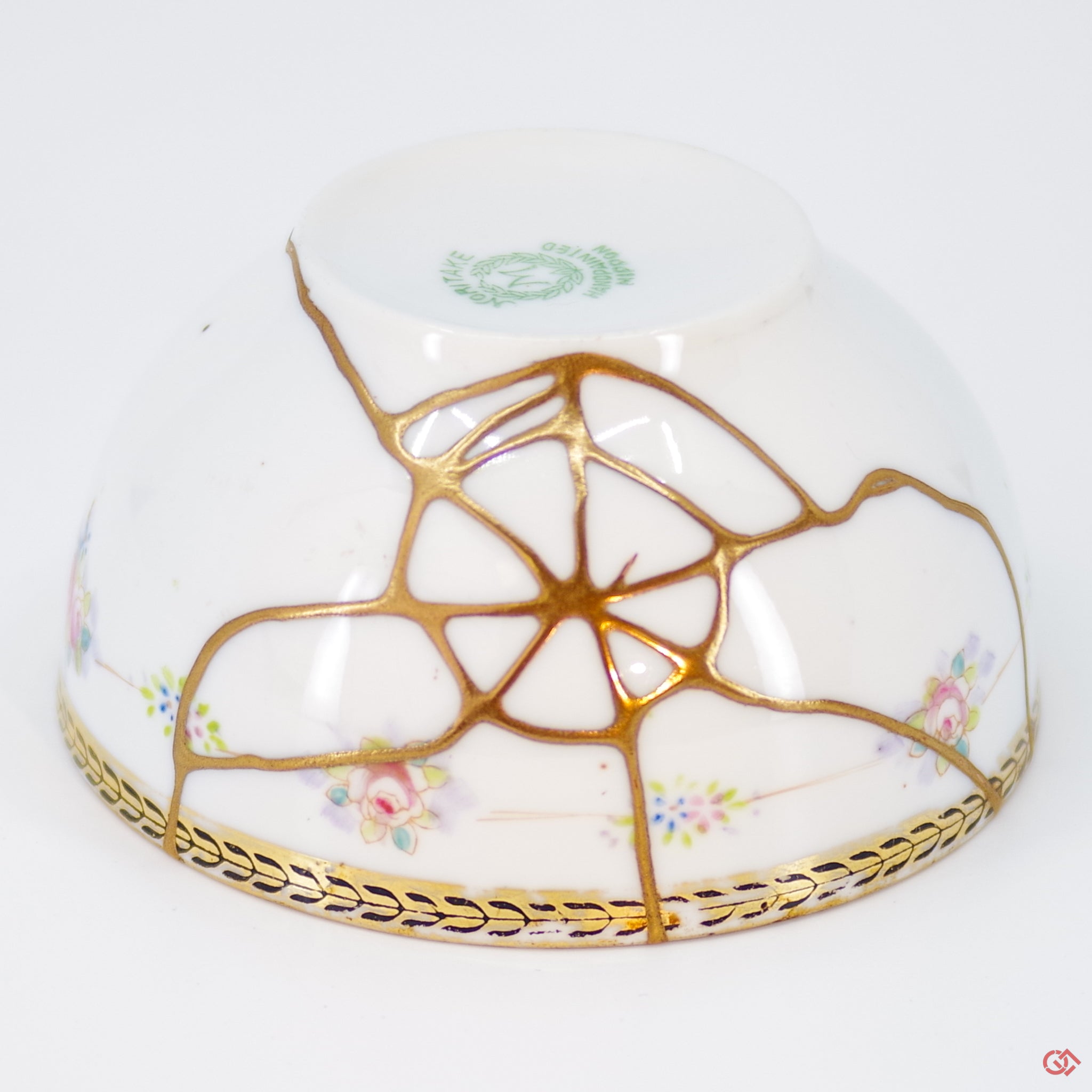 Close-up photo of an authentic Kintsugi pottery piece, showing the detail of its repairs and craftsmanship