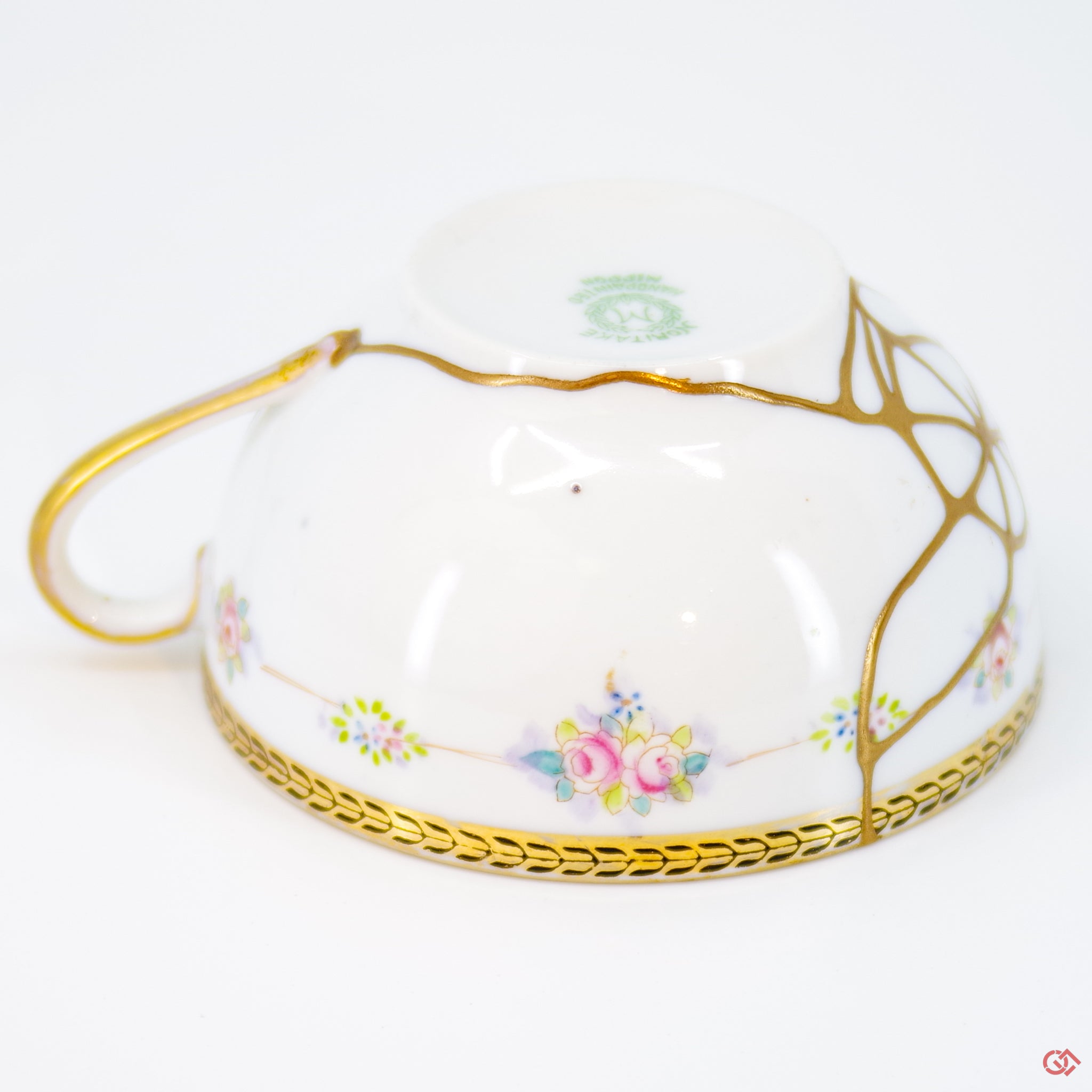 Close-up photo of an authentic Kintsugi pottery piece, showing the detail of its repairs and craftsmanship