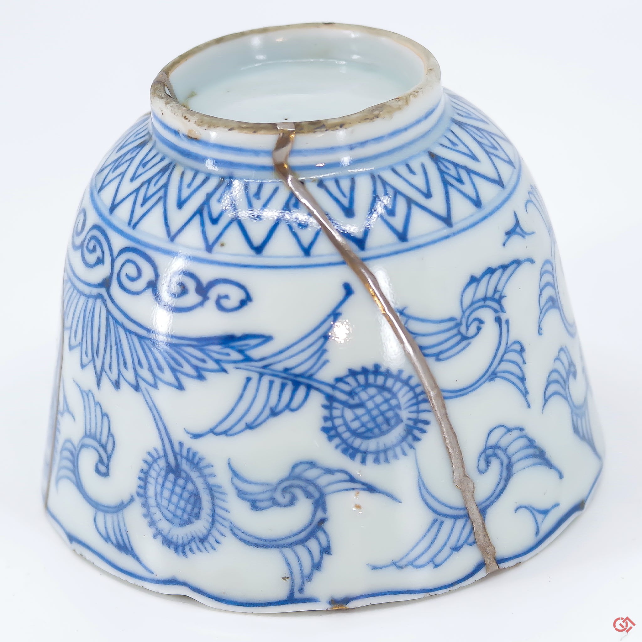 A close-up photo of an authentic Kintsugi pottery piece, showing the detail of its repairs and craftsmanship.