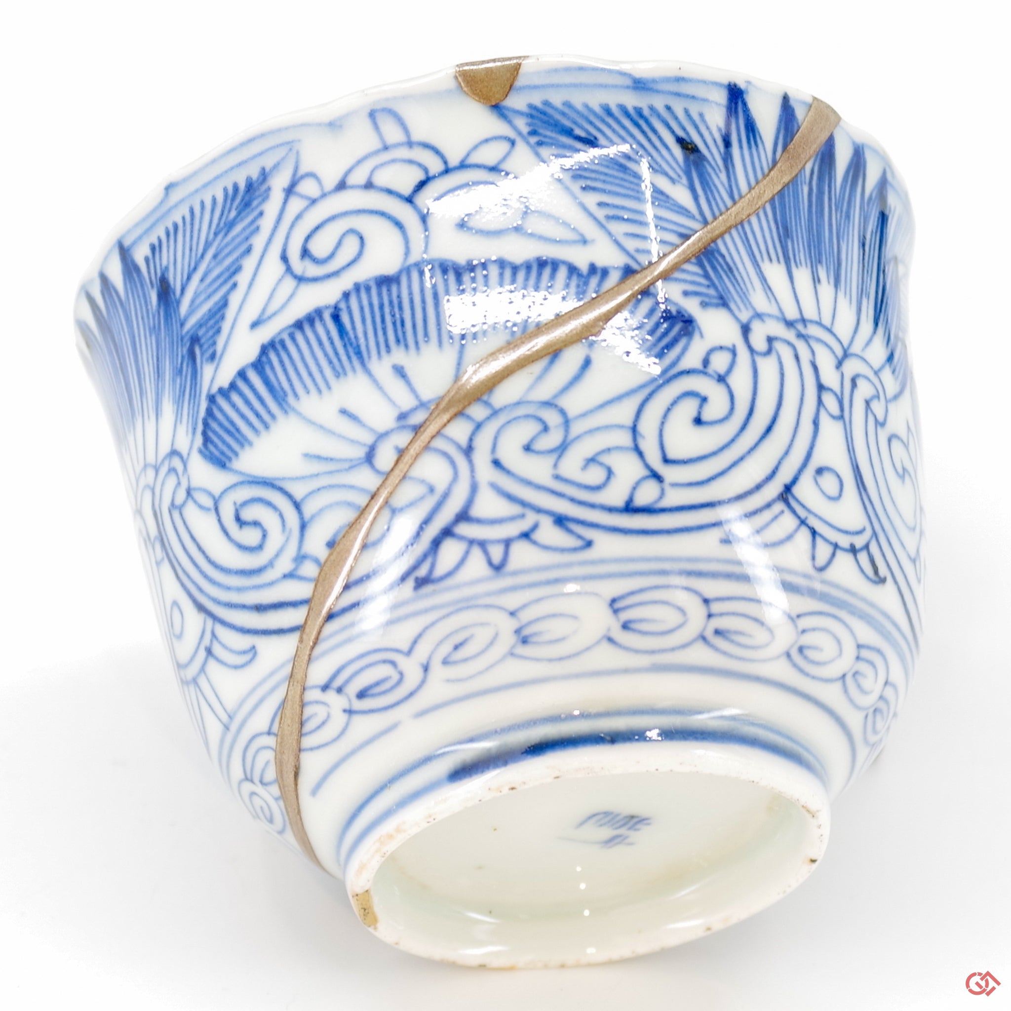 A close-up photo of an authentic Kintsugi pottery piece, showing the detail of its repairs and craftsmanship.