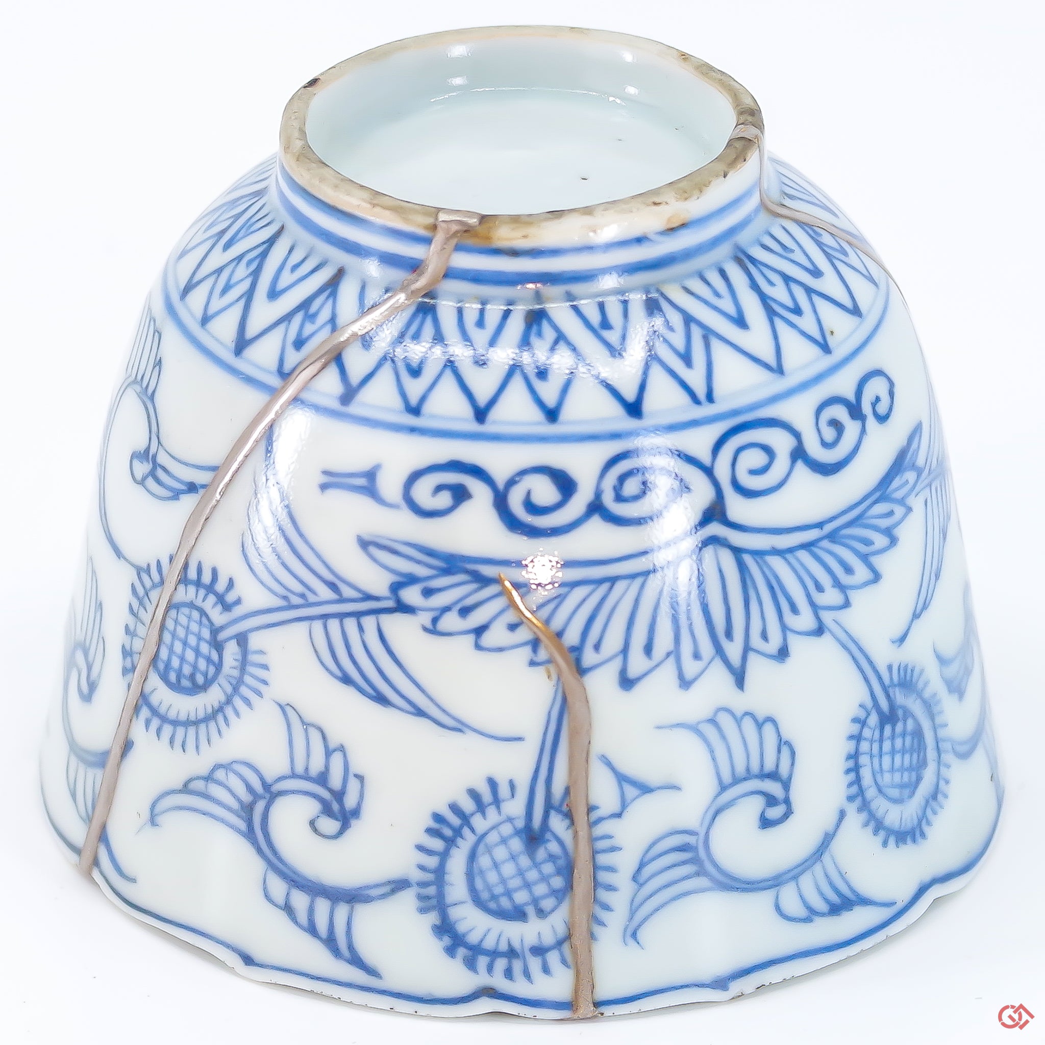 A close-up photo of an authentic Kintsugi pottery piece, showing the detail of its repairs and craftsmanship.