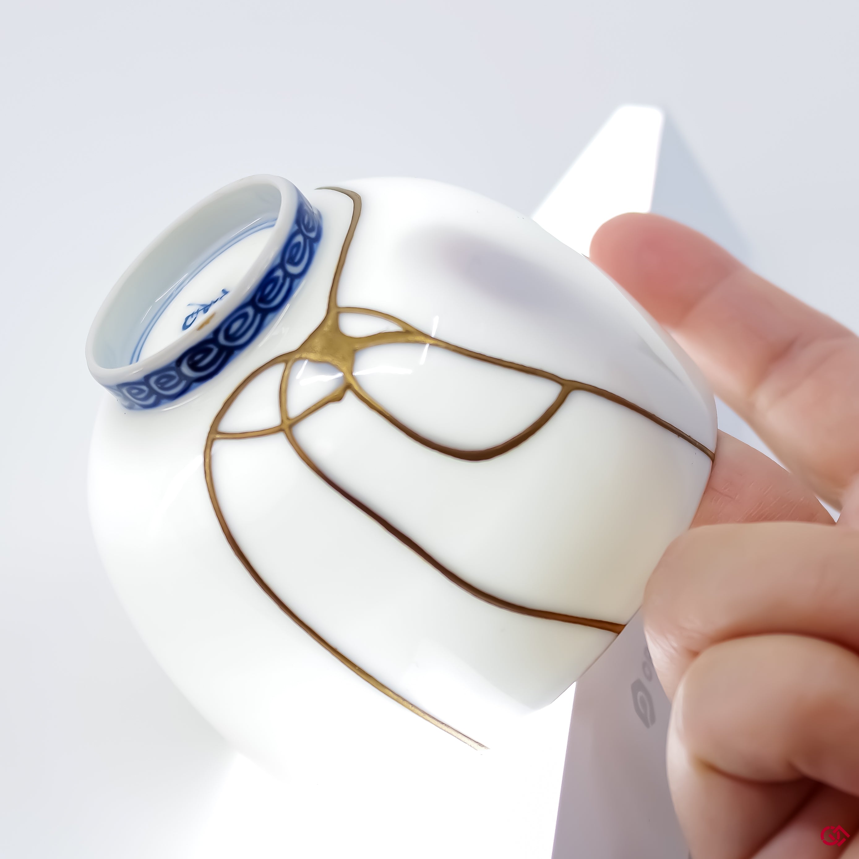 Close-up photo of an authentic Kintsugi pottery piece, showing the detail of its repairs and craftsmanship