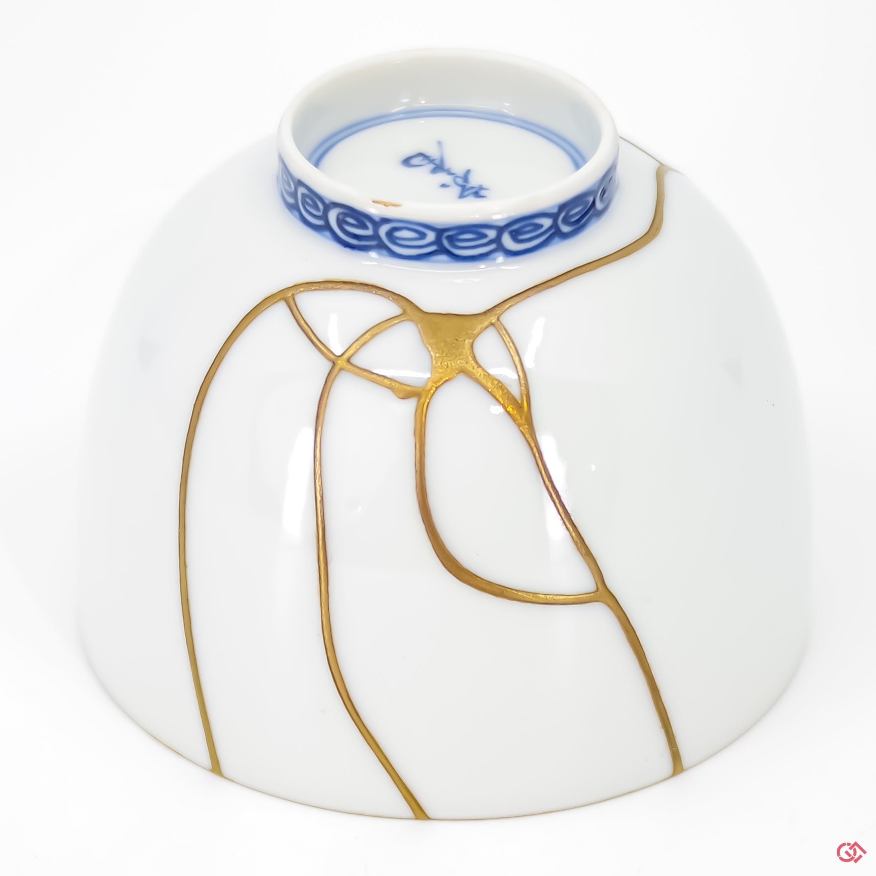 Close-up photo of an authentic Kintsugi pottery piece, showing the detail of its repairs and craftsmanship