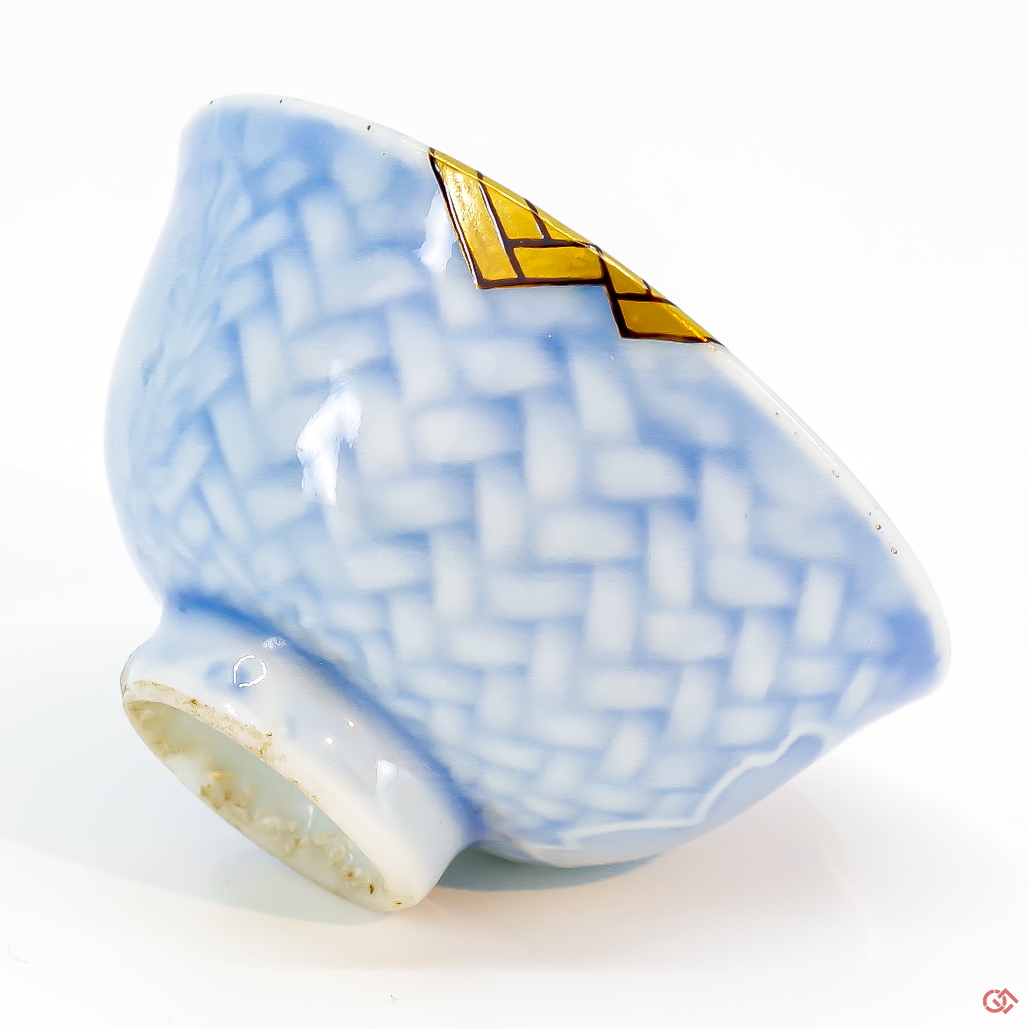 Close-up photo of an authentic Kintsugi pottery piece, showing the detail of its repairs and craftsmanship