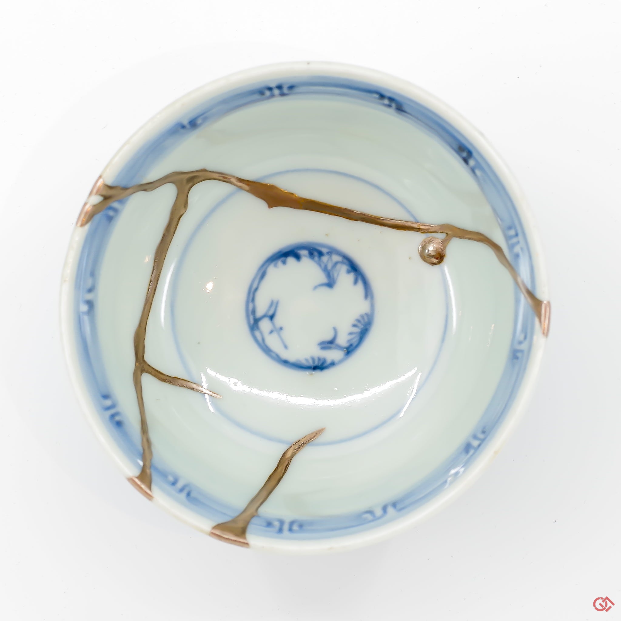 A photo of the top of an authentic Kintsugi pottery piece, showing its overall design and features.