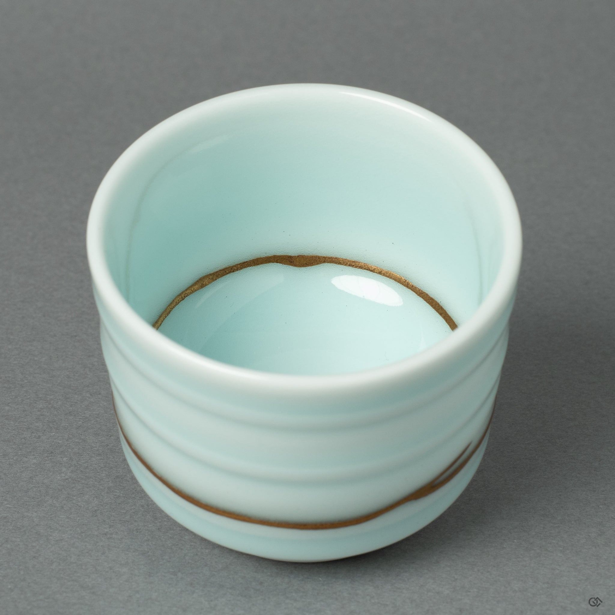 A close-up showcasing the subtle luster and texture of the 24k gold finish as it traces a delicate, hairline repair, demonstrating the range of the artisan's skill.