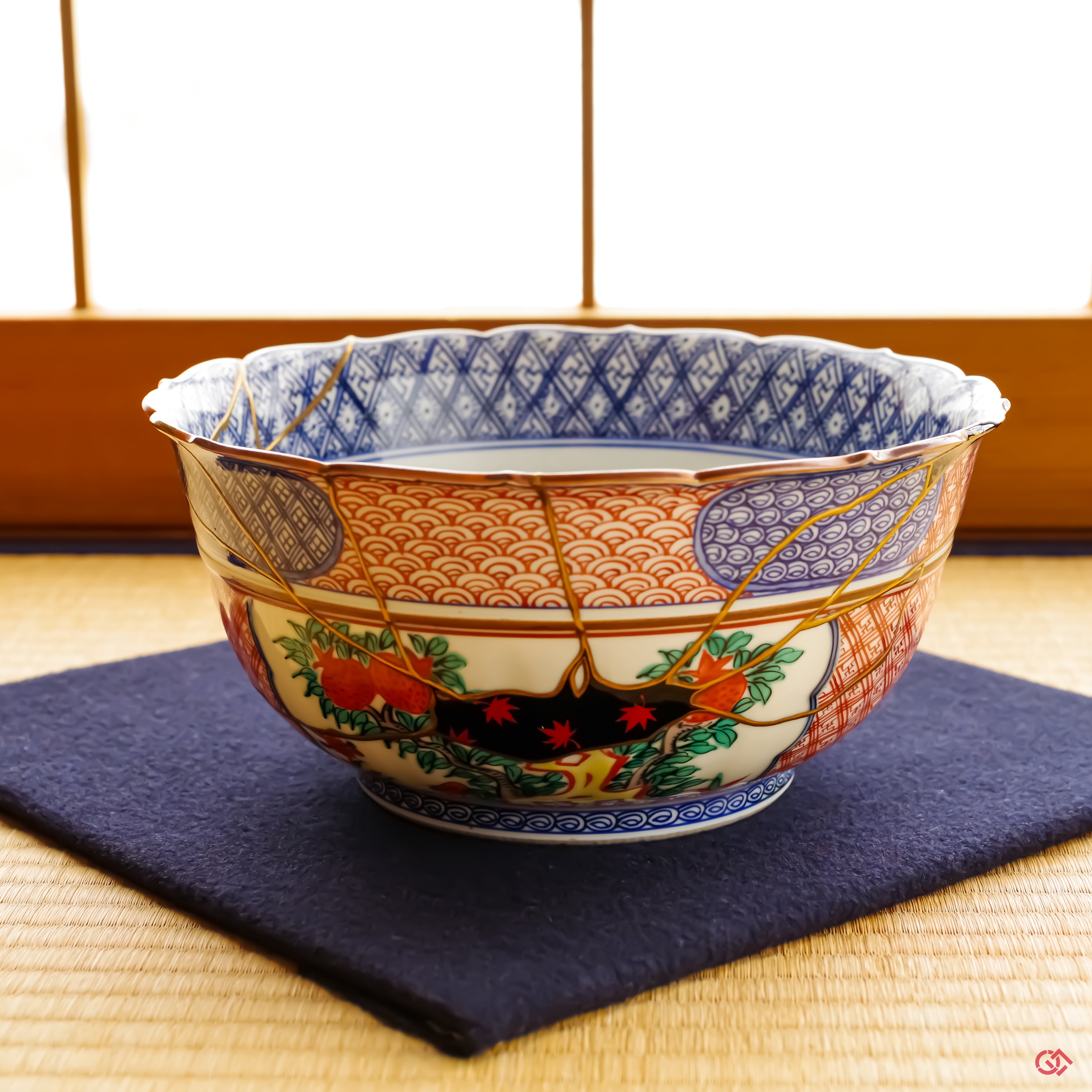 The resurrected Shonzui Kintsugi masterpiece, presented with reverence on a deep navy blue felt cloth over a traditional tatami mat. The setting highlights its monumental presence as a singular work of art.