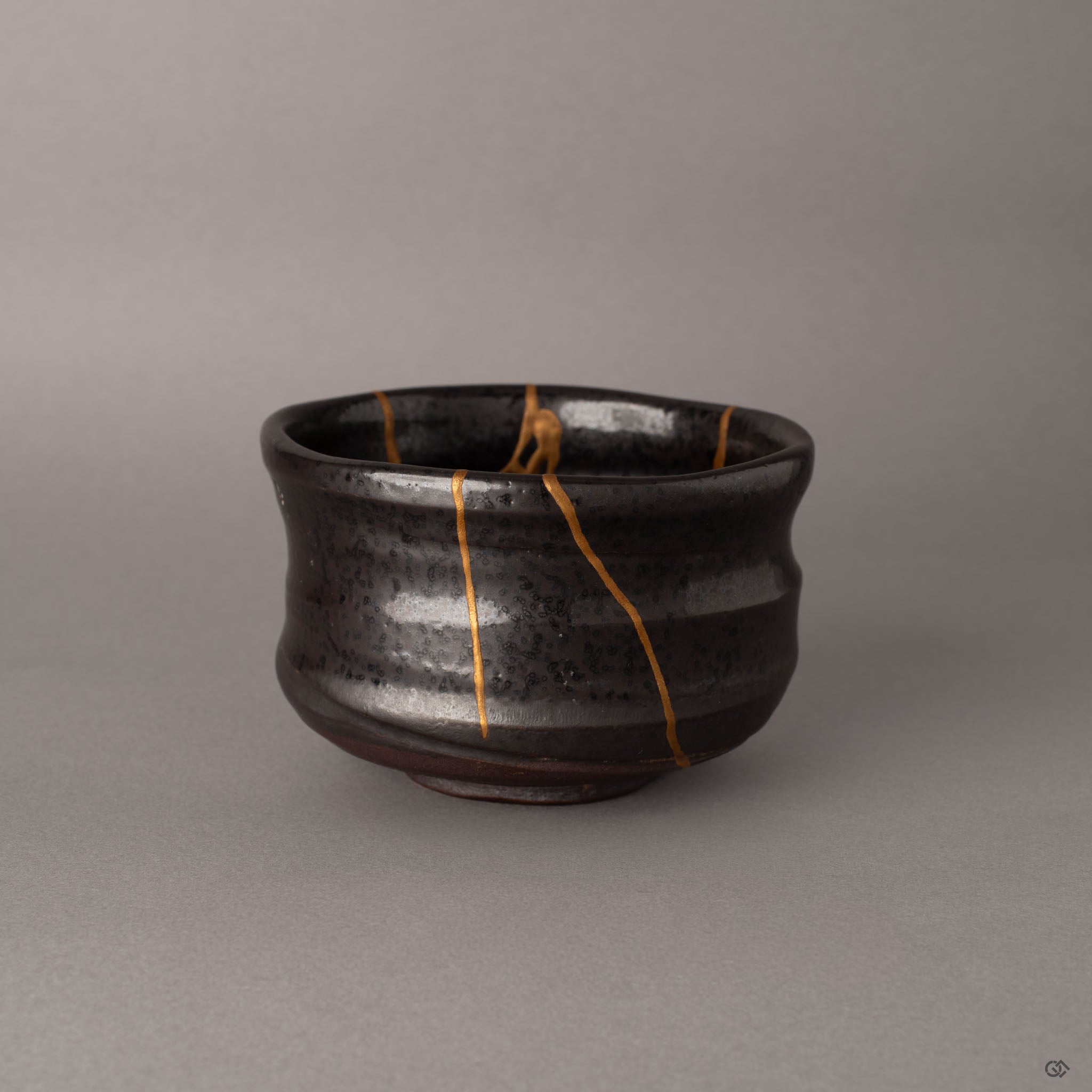 Side view of kintsugi Arita matcha bowl showing gold seams radiating across the robust porcelain form, embodying wabi-sabi simplicity.