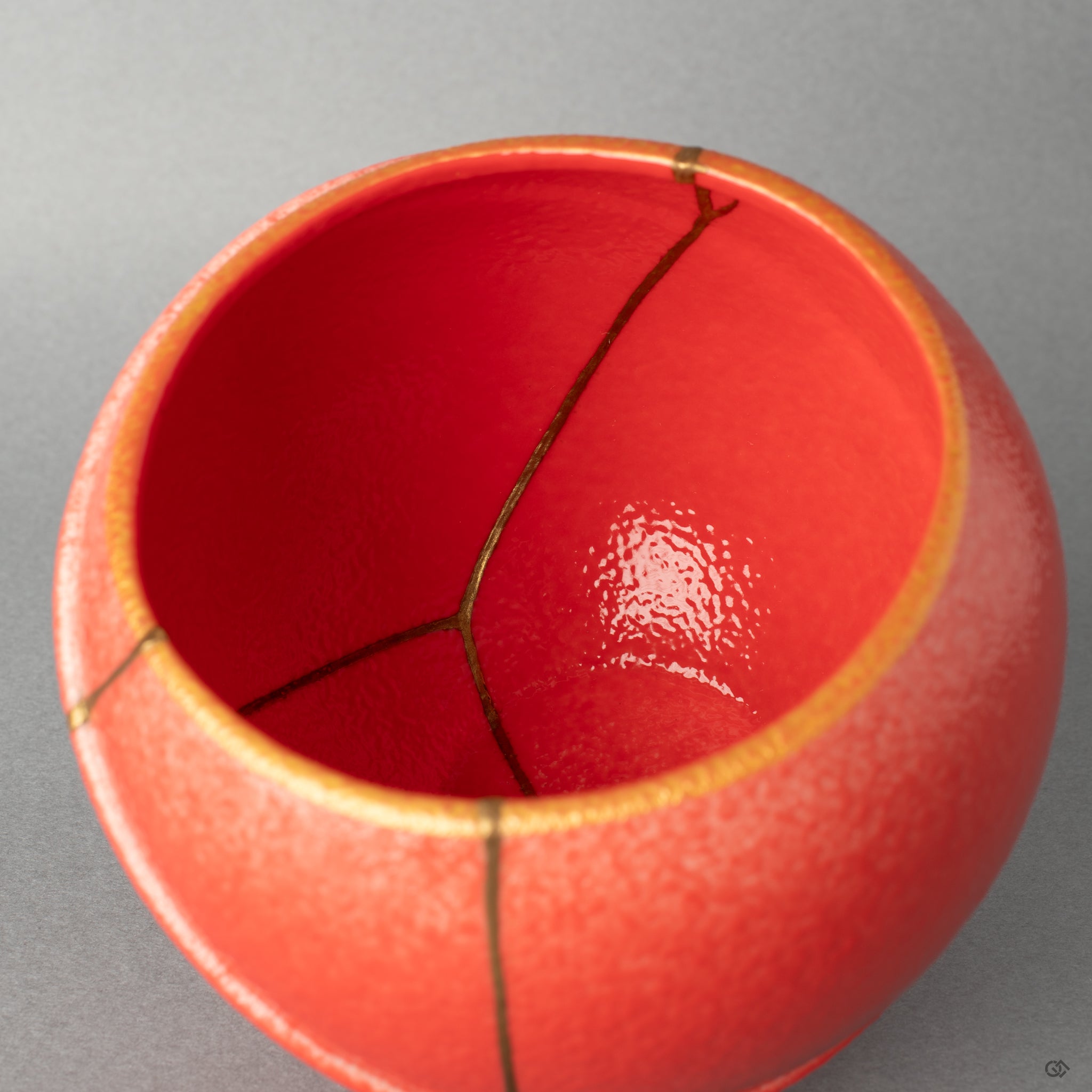 The gold line curves within the bowl, a gesture of kintsugi that offers healing through art to the fractured ceramic body.