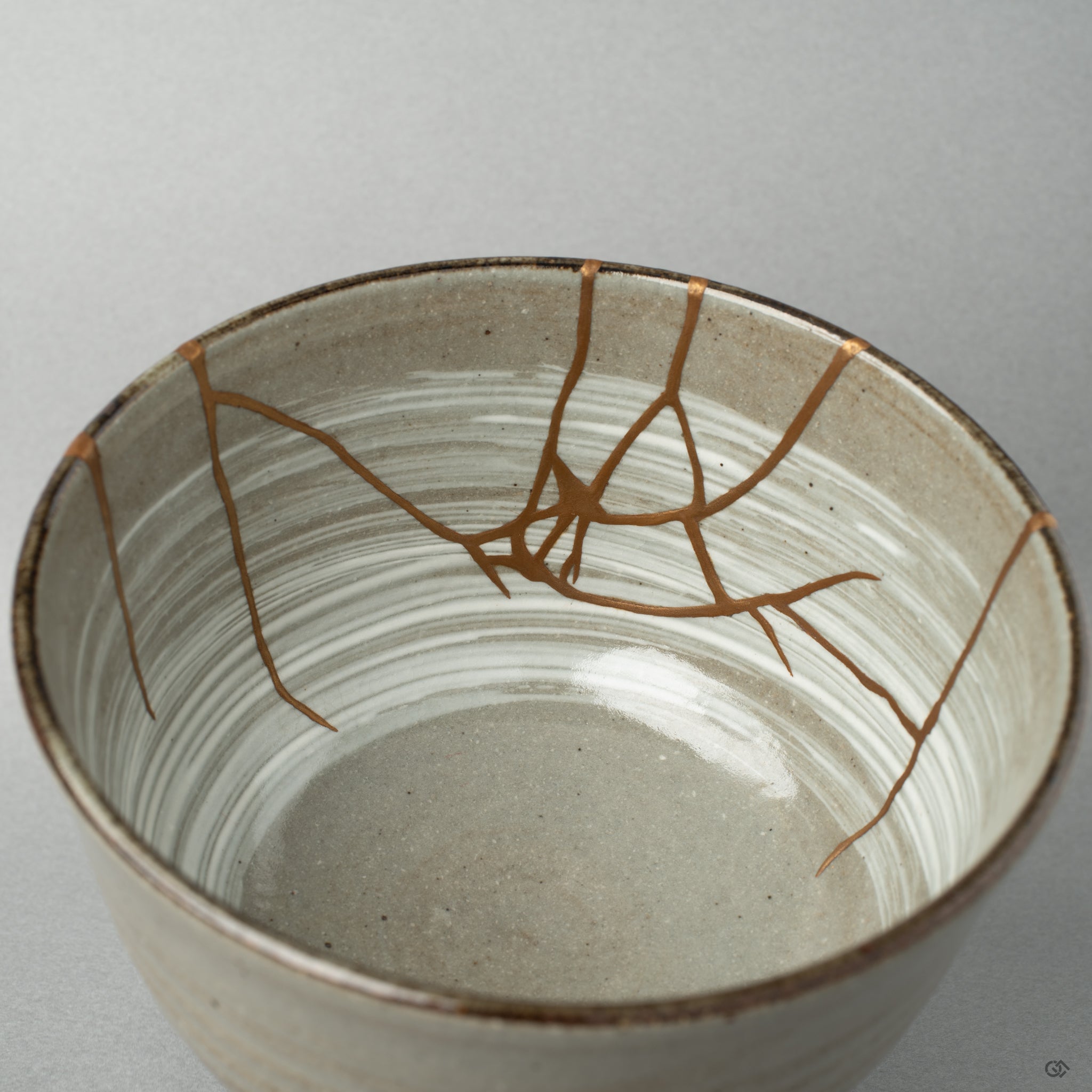 Close up on the interior kintsugi seam. The gold catches the light, giving the vessel a tangible piece of Japanese philosophy.