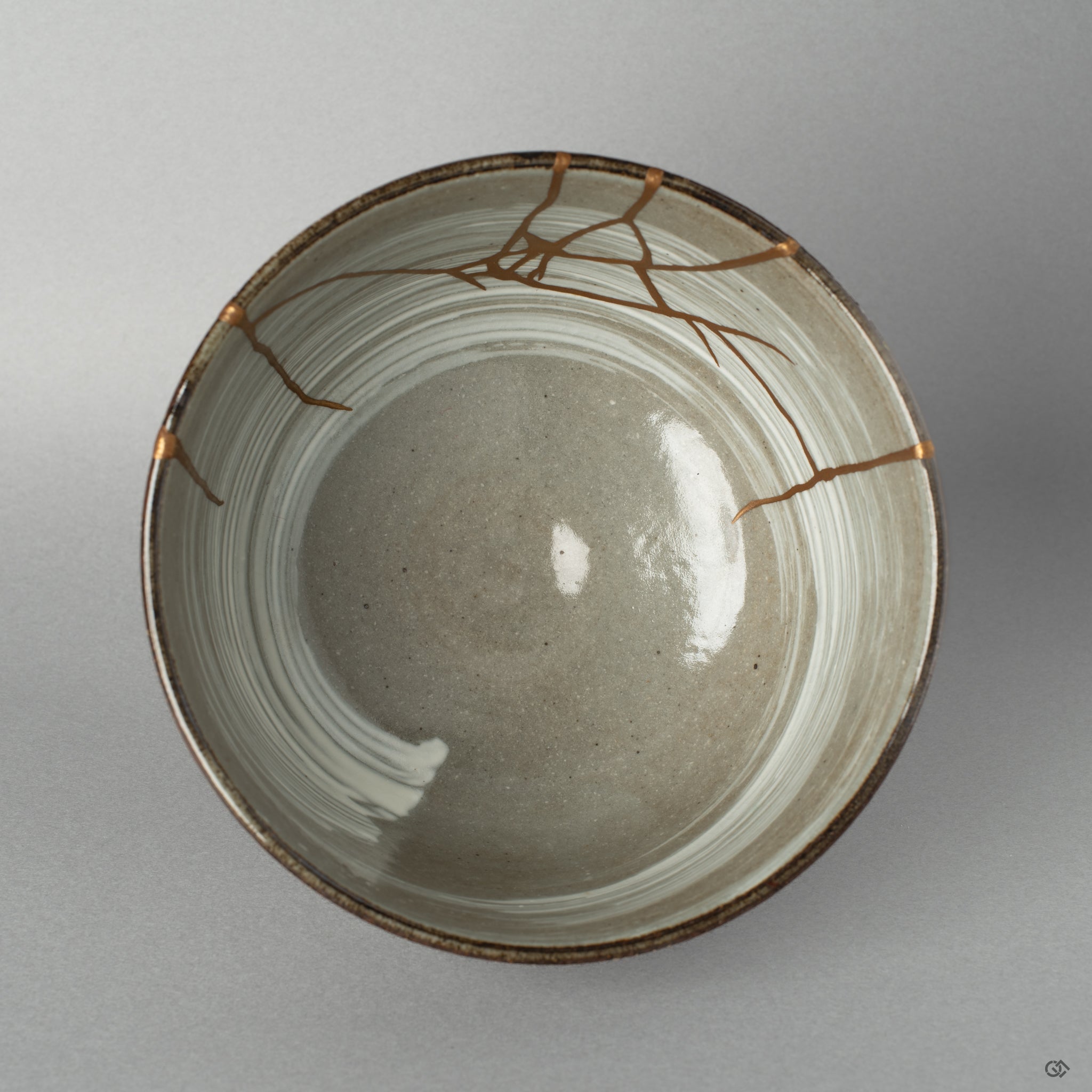 Top view of the kintsugi bowl revealing the delicate patterns of mending, an expression of perfectly imperfect form.