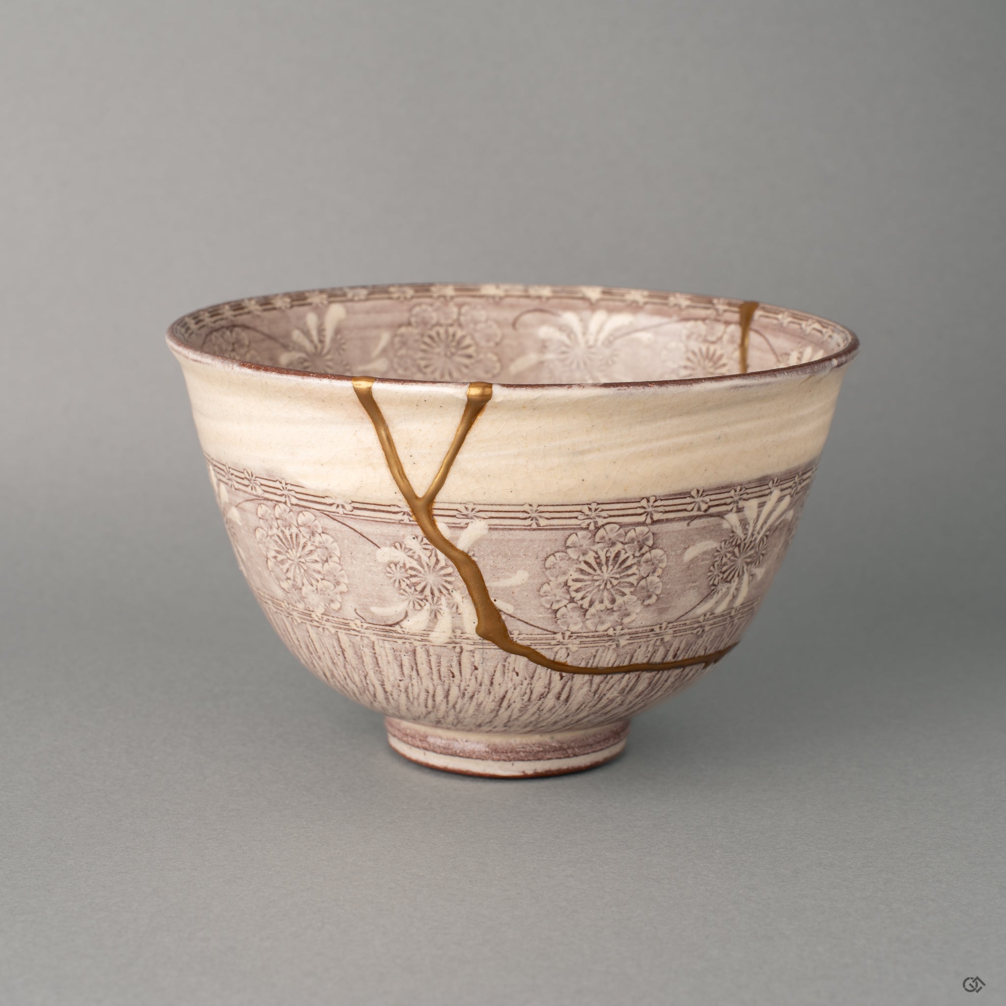 Soft purple Kyoto matcha bowl with pressed Mishima patterns, gold kintsugi seams winding through the glaze in wabi-sabi stillness.