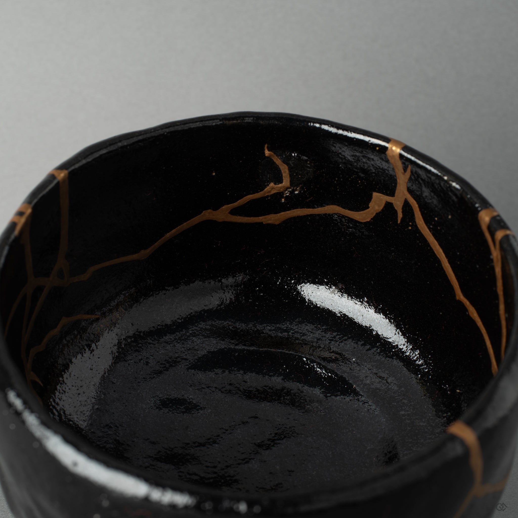Detail of burnished gold kintsugi inside a Kyoto matcha bowl, patient urushi layers beneath visible resilience.