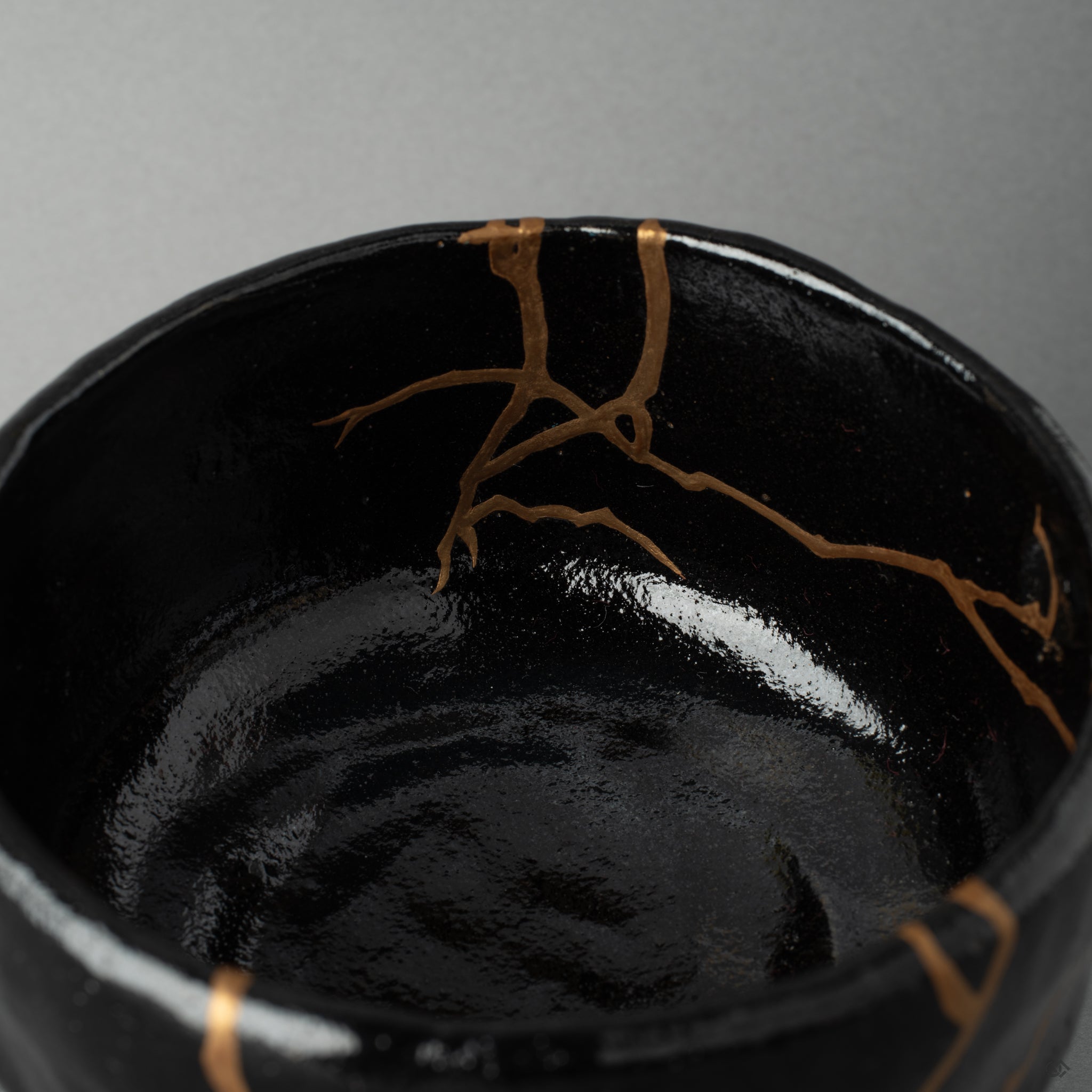 Close view of urushi and gold kintsugi work inside a Kyoto bowl, a tactile history you can almost feel.
