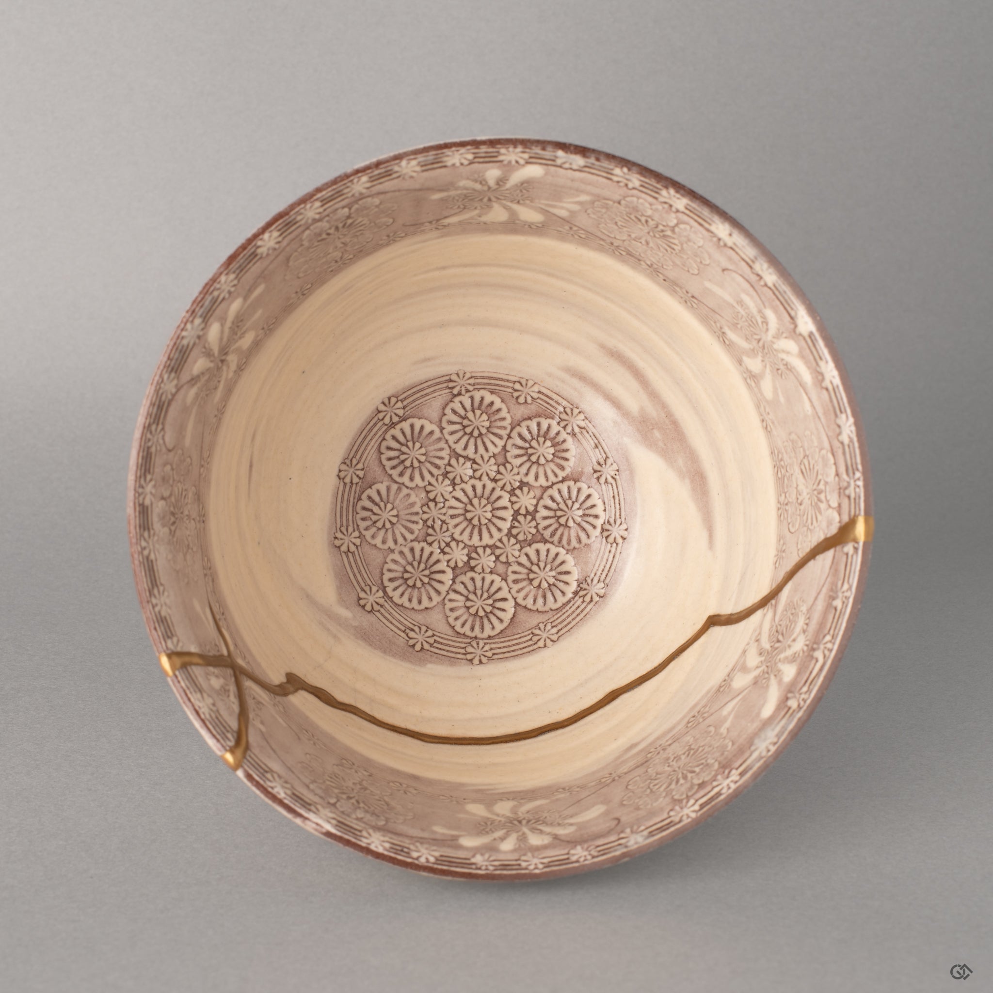 Looking down into a Kyoto matcha bowl, gold kintsugi lines radiate across the lavender interior, a quiet beauty seen from above.