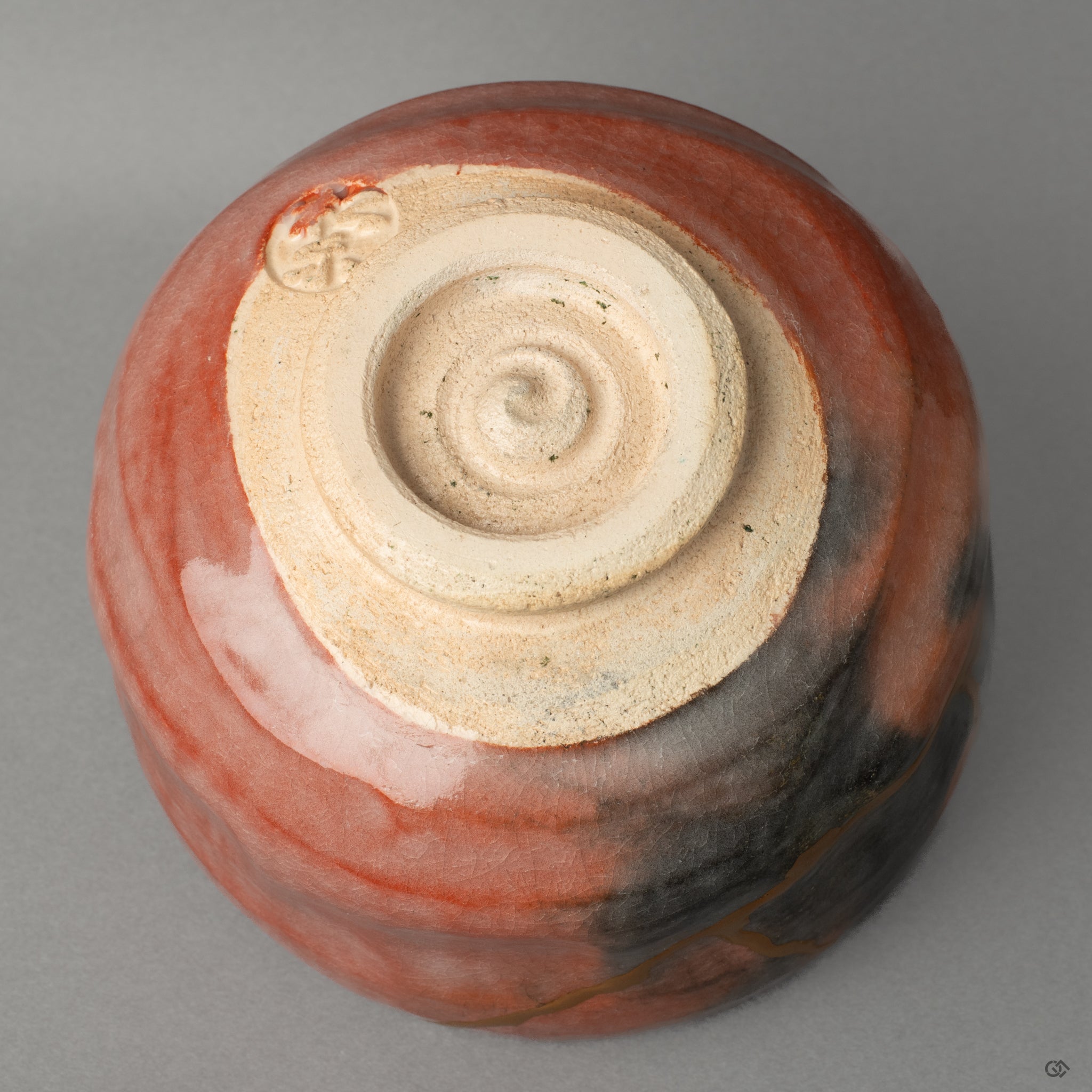 Bottom view of the Kyoto ware bowl, showing the artisan's mark and kintsugi seam, a sign of cultural heritage and authentic craftsmanship.