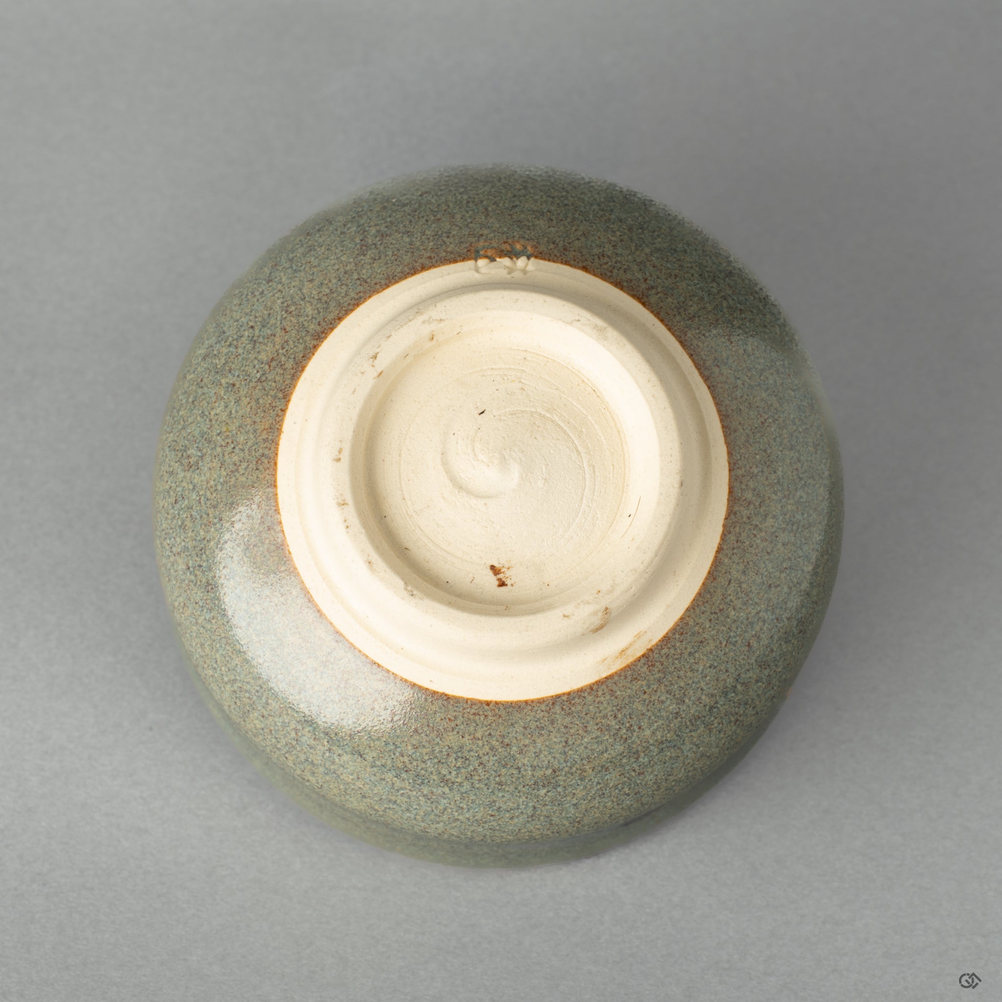 Bottom view of a Kyoto matcha bowl repaired with 24k gold kintsugi, a testament to cultural storytelling through form.