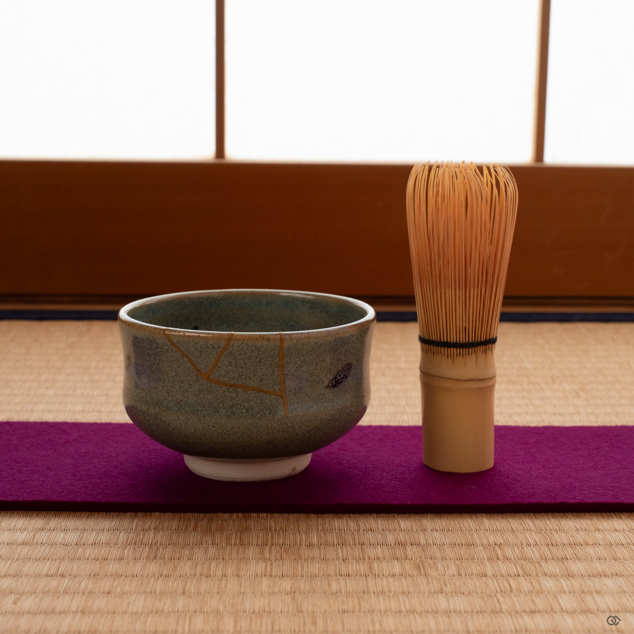 Kyoto kintsugi matcha bowl on tatami mat with tea whisk, 24k gold seams glowing softly—a moment of contemplation.