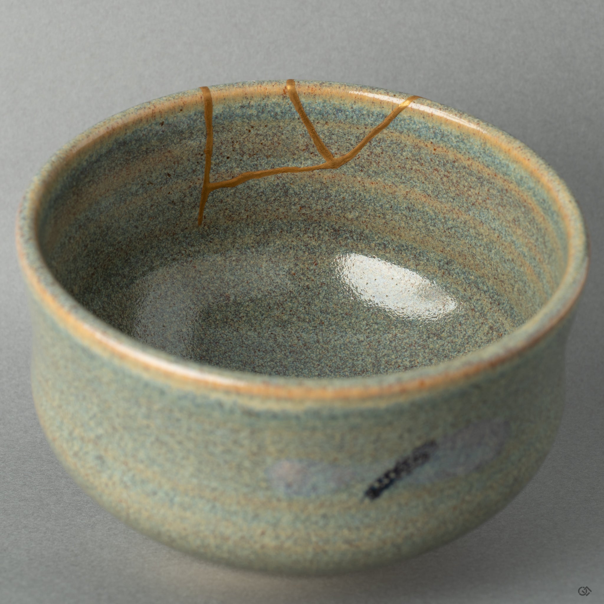 Close-up of golden kintsugi seams inside a Kyoto matcha bowl, capturing the grace found in visible imperfection.