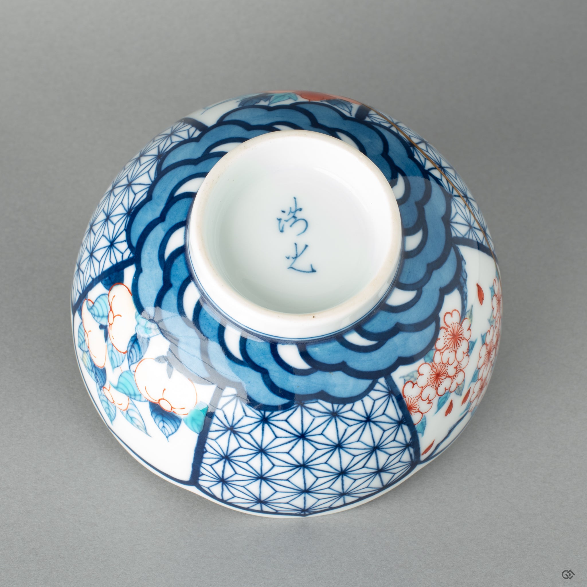 Bottom view of a Nabeshima kintsugi matcha bowl with 24k gold seams, a testament to visible resilience and craft.