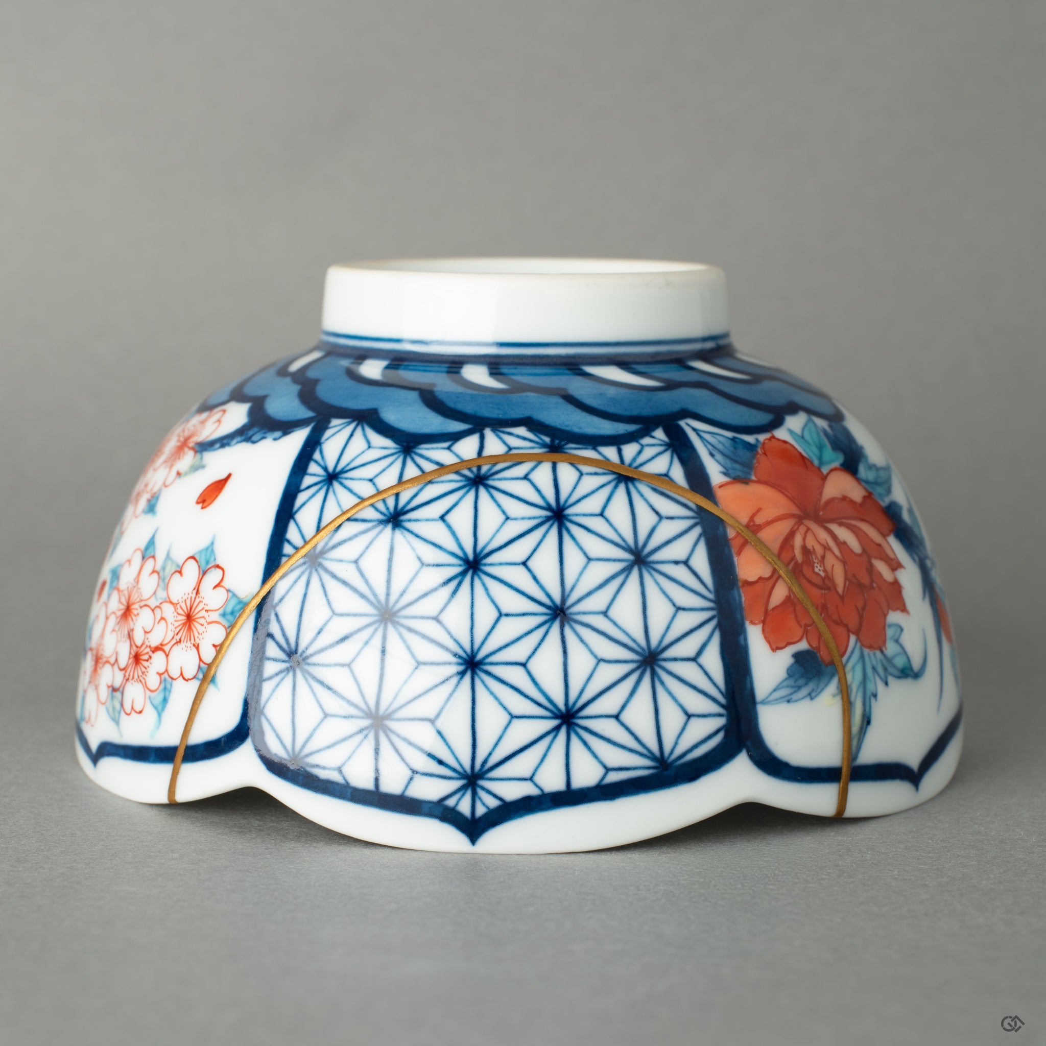 Close-up of 24k gold kintsugi seams on Nabeshima porcelain, where scars become beauty through traditional restoration.