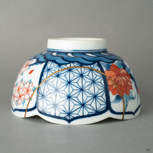 Close-up of 24k gold kintsugi seams on Nabeshima porcelain, where scars become beauty through traditional restoration.