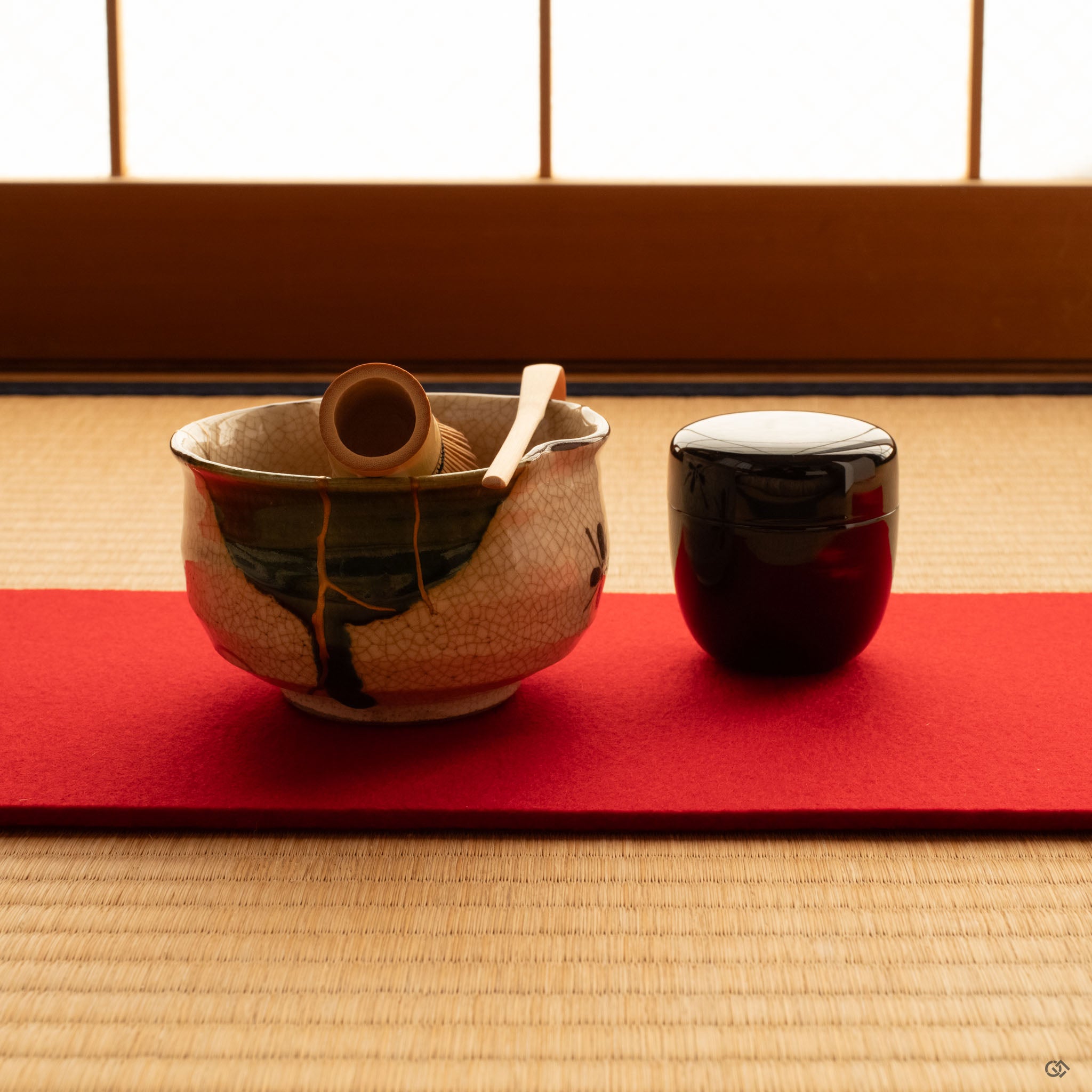 Kintsugi Oribe matcha bowl on tatami in soft light, gold lines and copper-green glaze settling into a space of slow craft and intention.