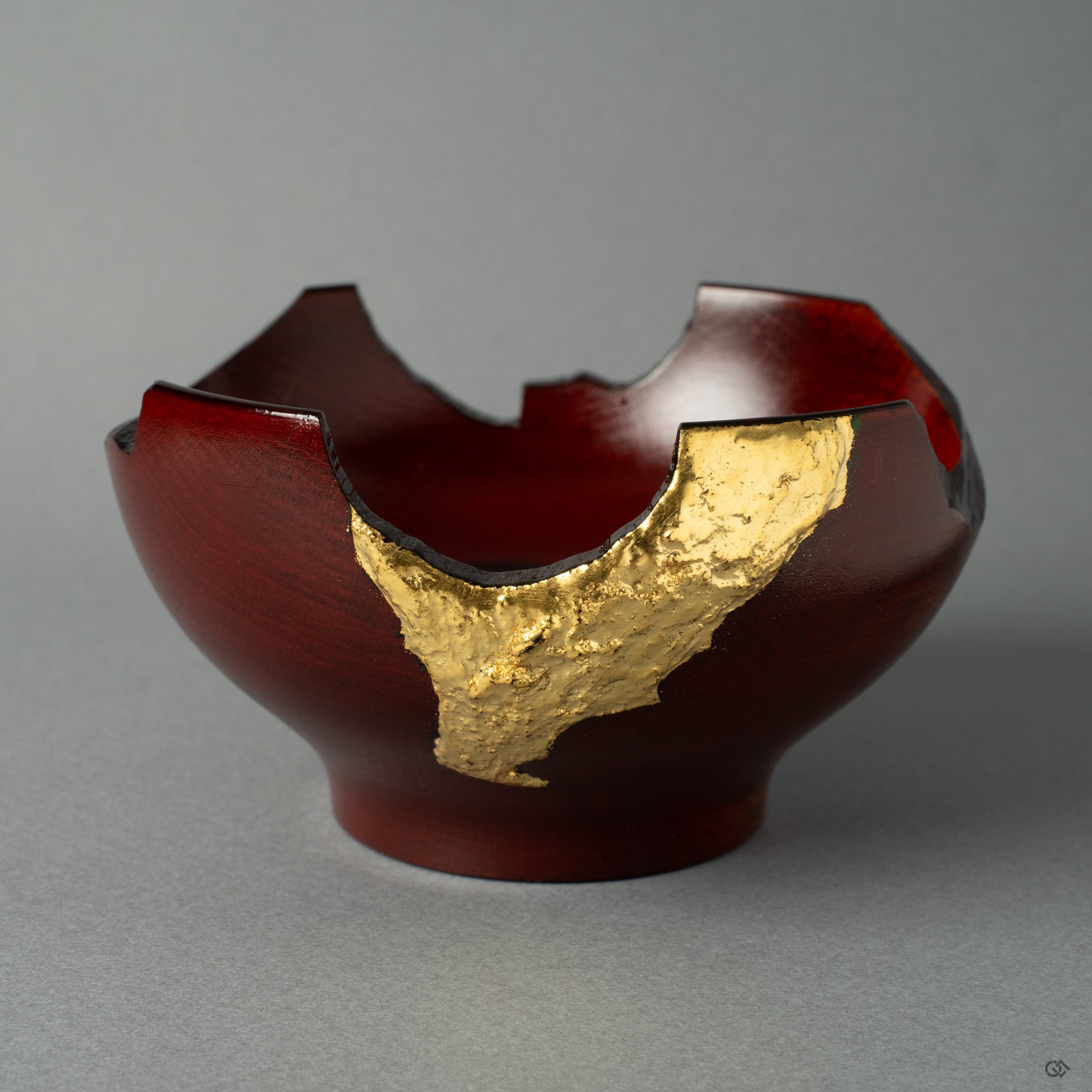 Detail close-up view of a rock-like lacquerware piece with gold leaf on a lacquered wooden cup, crafted in the style of wabi-sabi. It exudes wabi-sabi elegance and Japanese artistry.