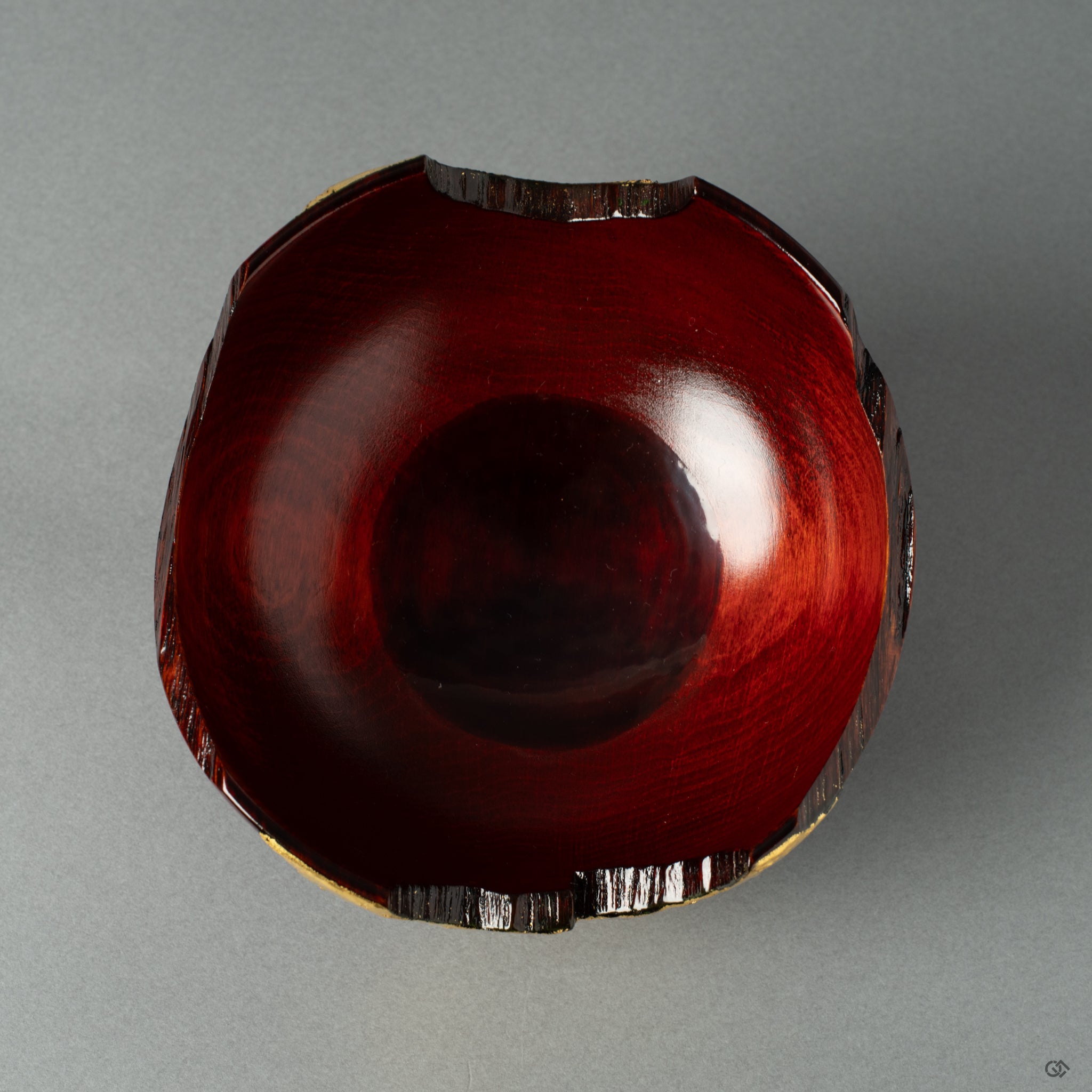 Top view view of a rock-like lacquerware piece with gold leaf on a lacquered wooden cup, crafted in the style of wabi-sabi. It exudes wabi-sabi elegance and Japanese artistry.