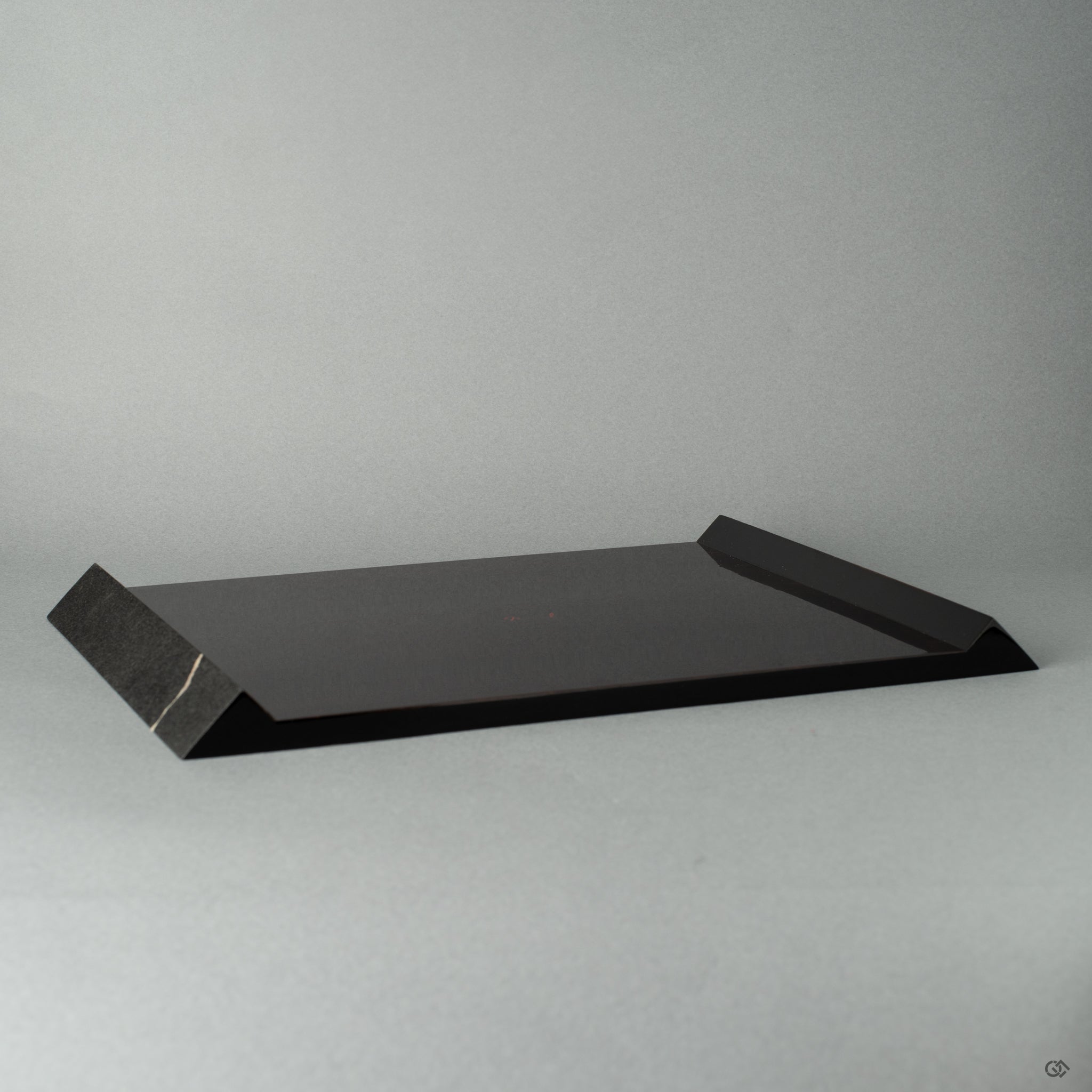 Flat black wooden plate with, fine silver technique, shown from the side view, highlighting Japanese craftsmanship and wabi-sabi elegance