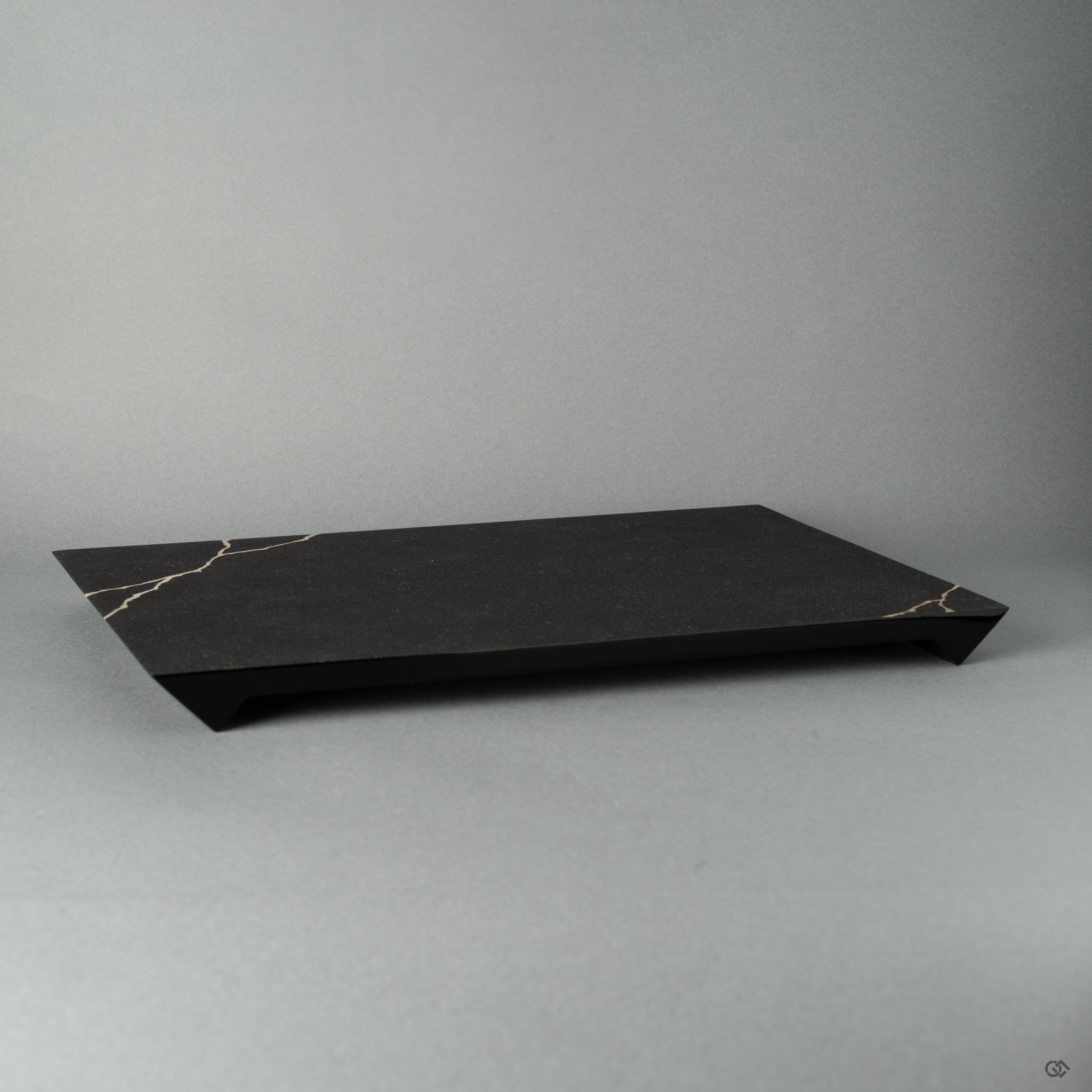 Flat black wooden plate with, fine silver technique, shown from the side view, highlighting Japanese craftsmanship and wabi-sabi elegance