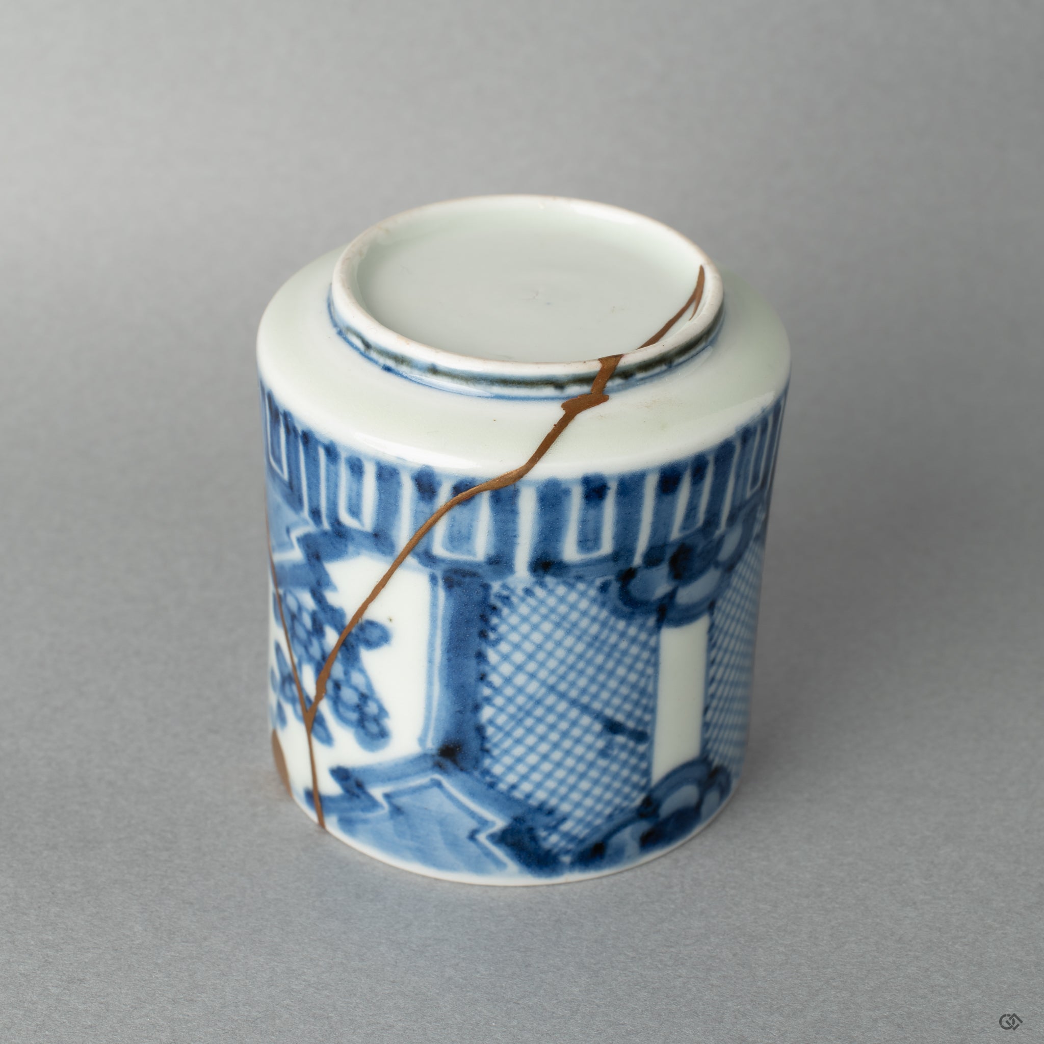 The gold kintsugi glows softly in the shadow; you can almost see the patina of time held in this authentic art collectible.