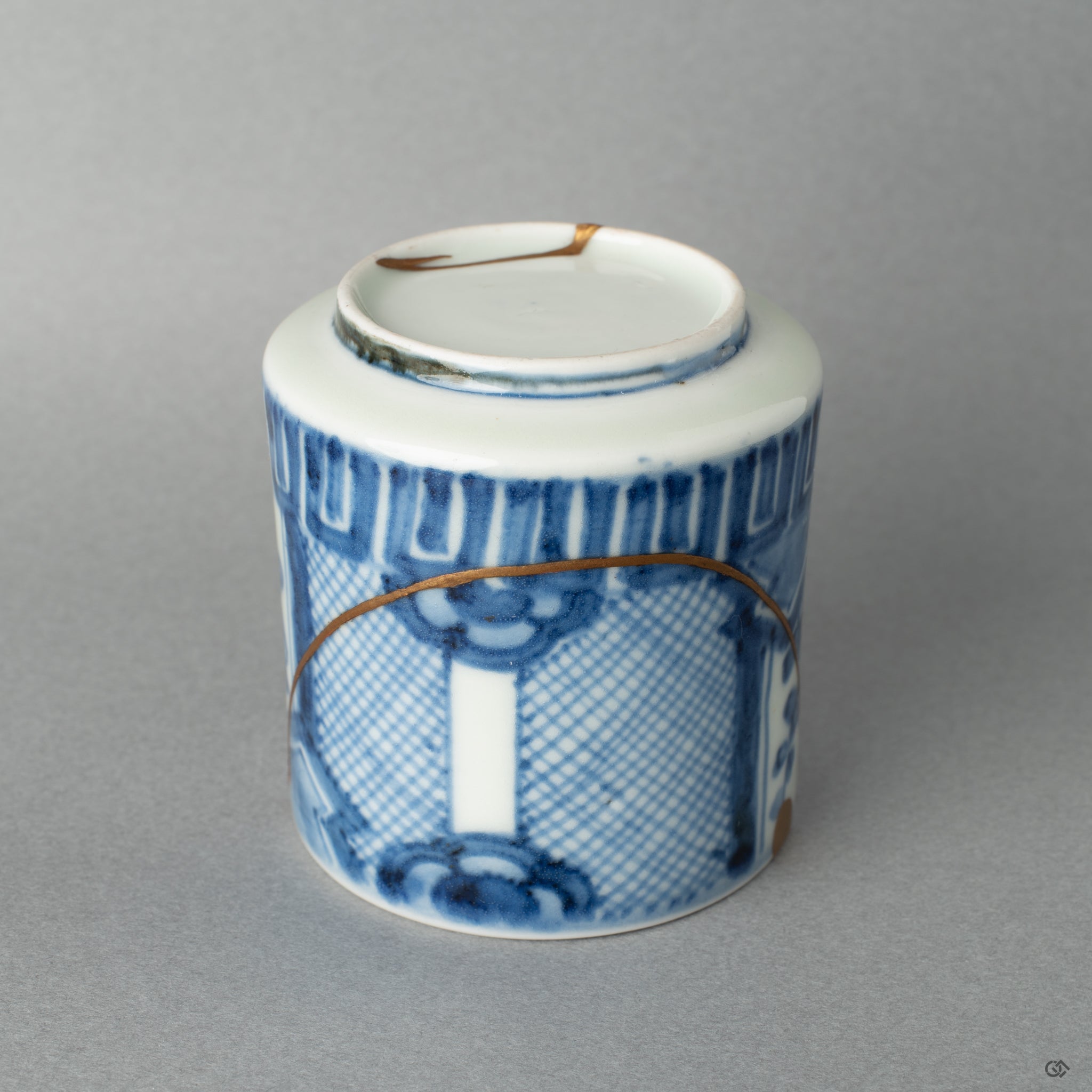 Detailed view of the porcelain pattern where the gold kintsugi flows, a tangible piece of Japanese philosophy made visible.