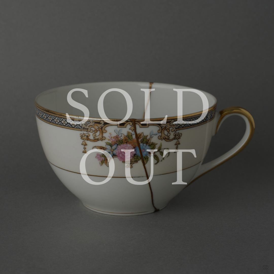 Sold out: 24K gold kintsugi Early Noritake tea cup, pre-war white porcelain with hand-painted floral motifs, restored with natural urushi lacquer.