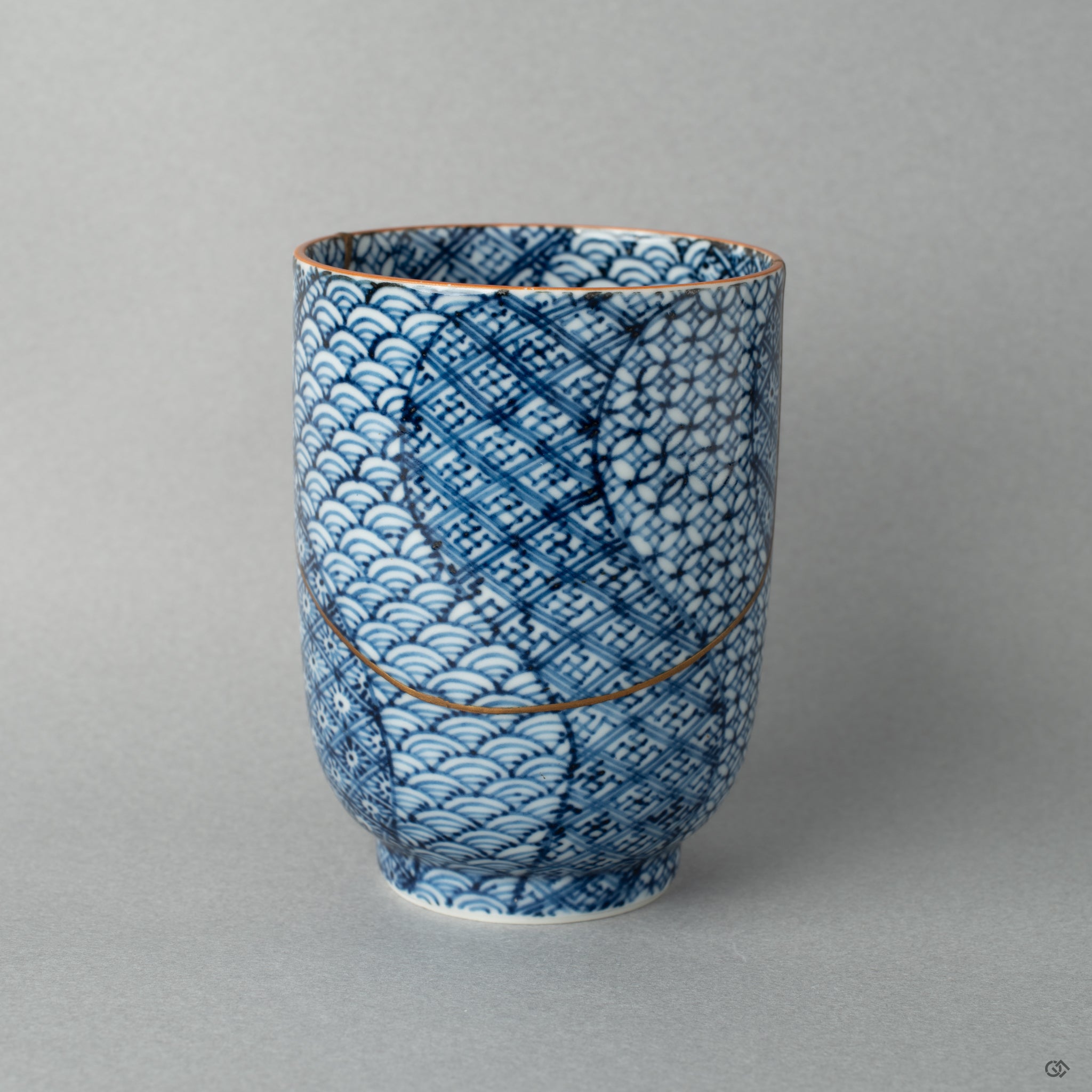 Alternate side of a Kyoto kintsugi tea cup, where gold meets porcelain in an expression of crafted resilience.