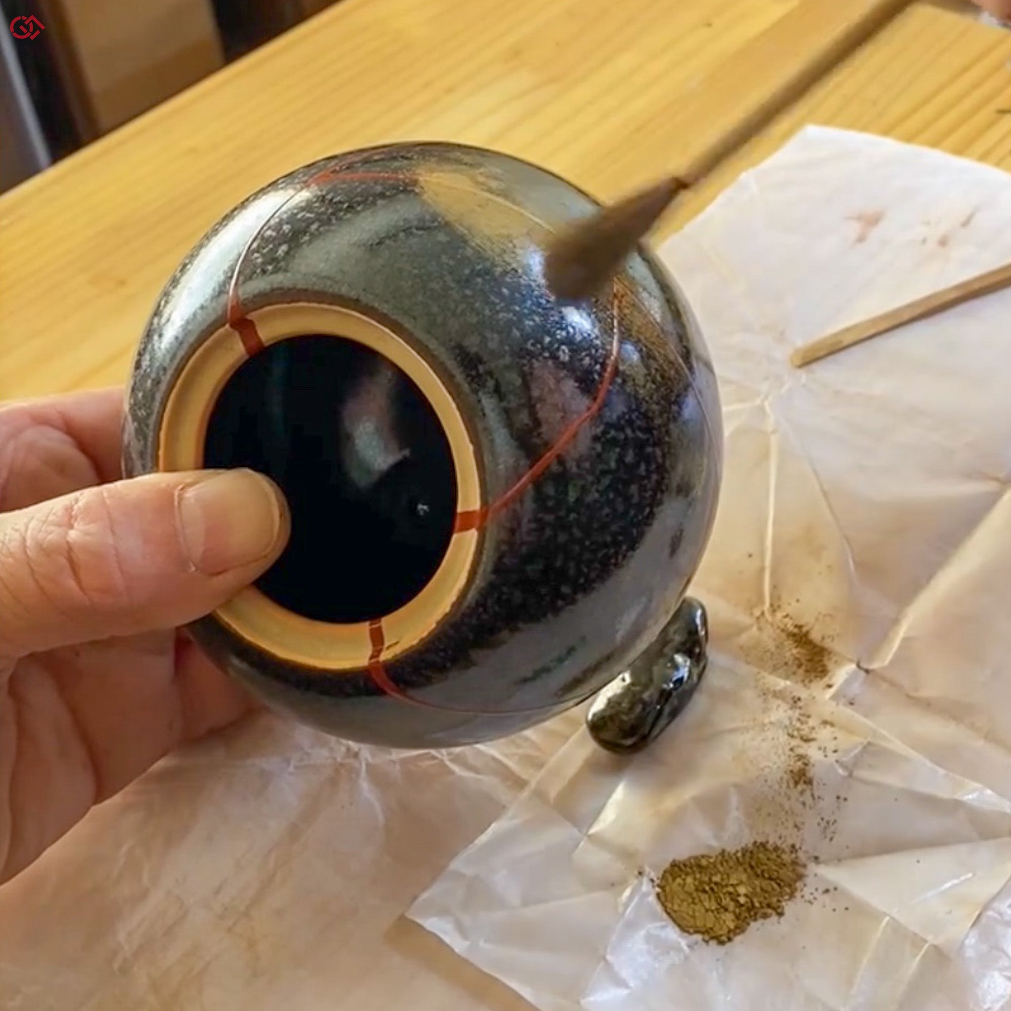 Sprinkling gold powder during traditional Kintsugi