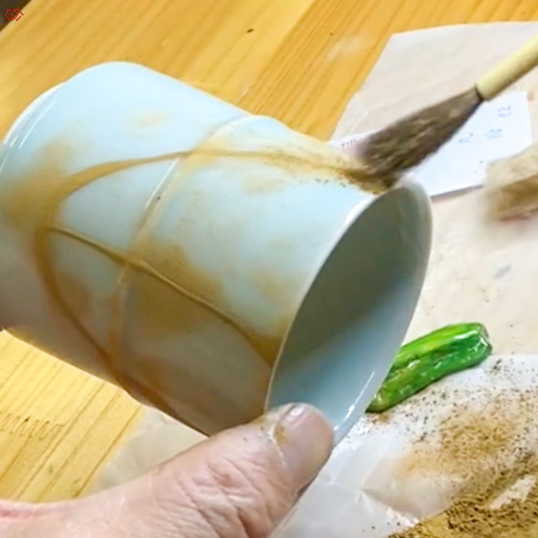 Sprinkling gold powder during traditional Kintsugi
