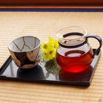 Photo of an authentic Kintsugi pottery piece being used in a real-world setting,