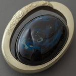Top view of Union of Skies by Keiko Hata, showing the oval lacquer dome encircled by a gilded band, like a planet within a ring.